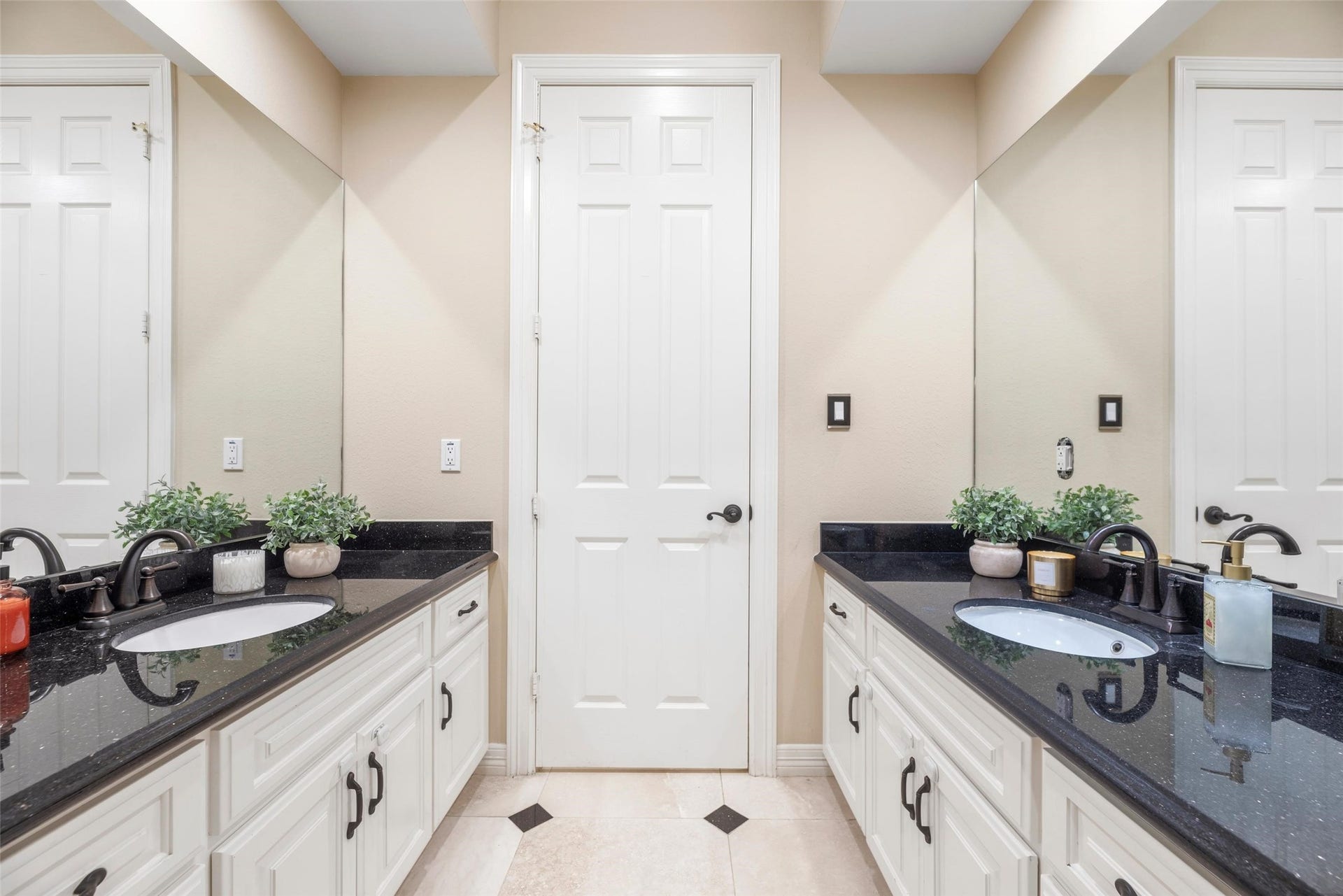 Downstairs guest bath has double vanities.