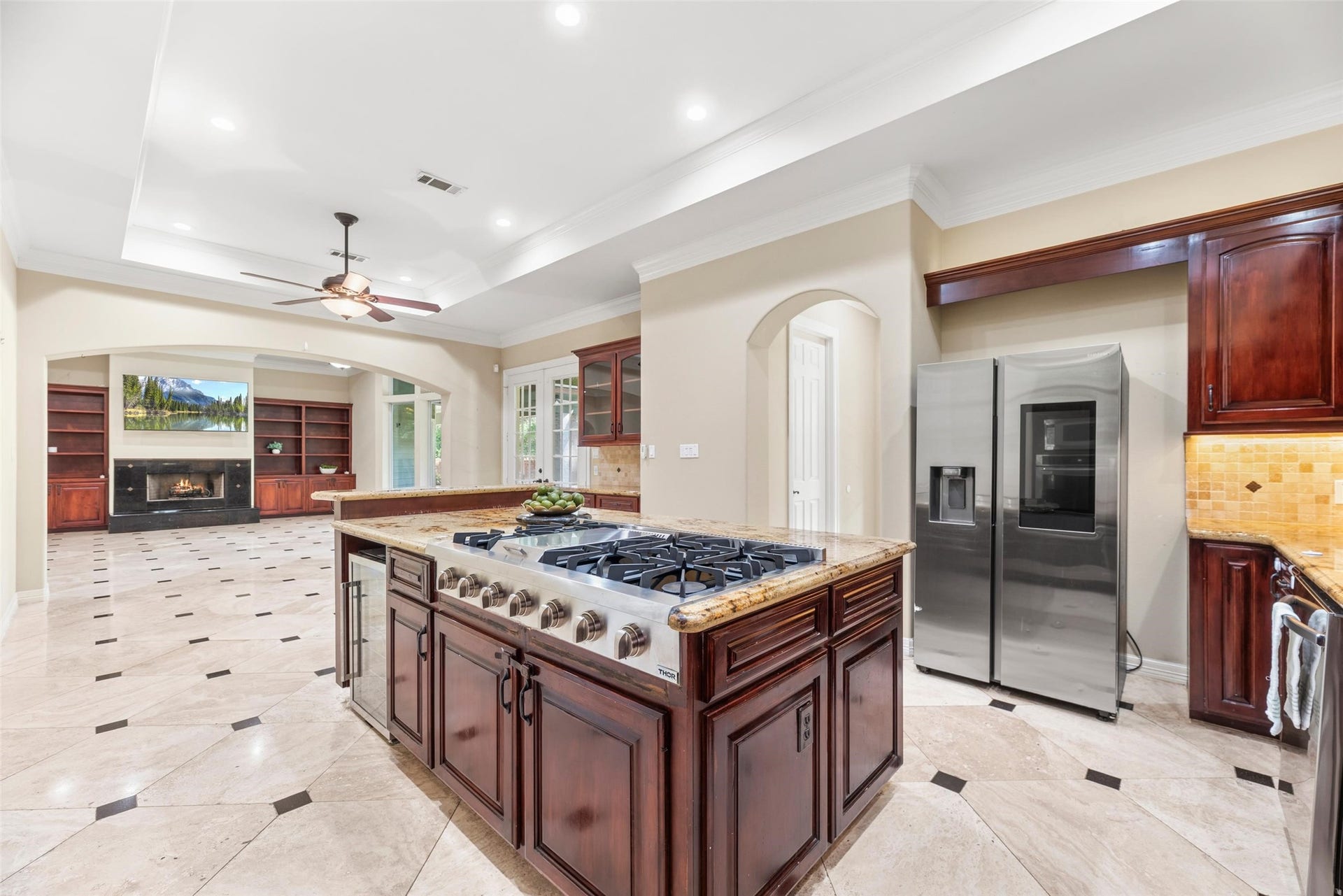 Bright kitchen with large 6 burner gas stove and double ovens.