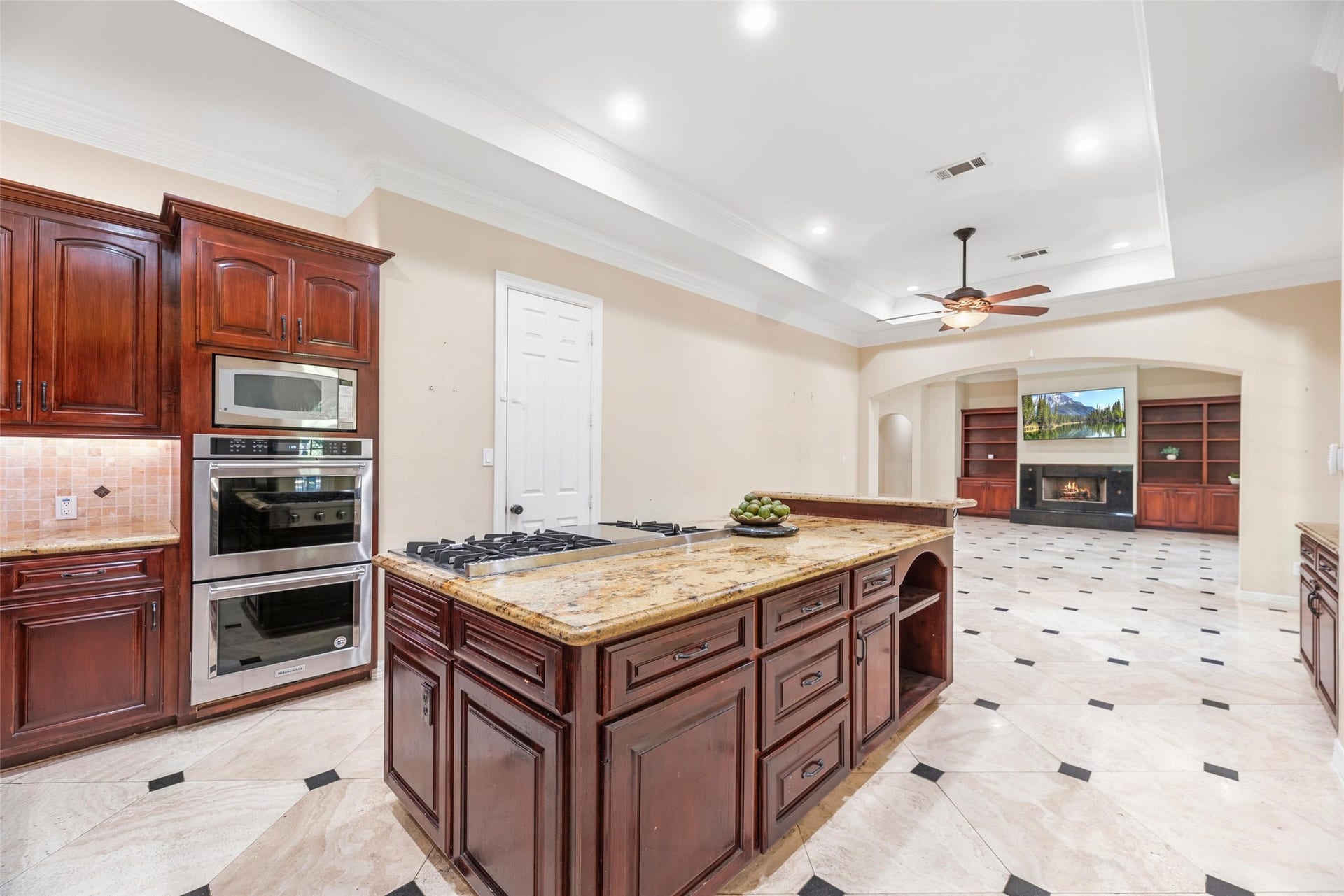 Bright kitchen with large 6 burner gas stove and double ovens.