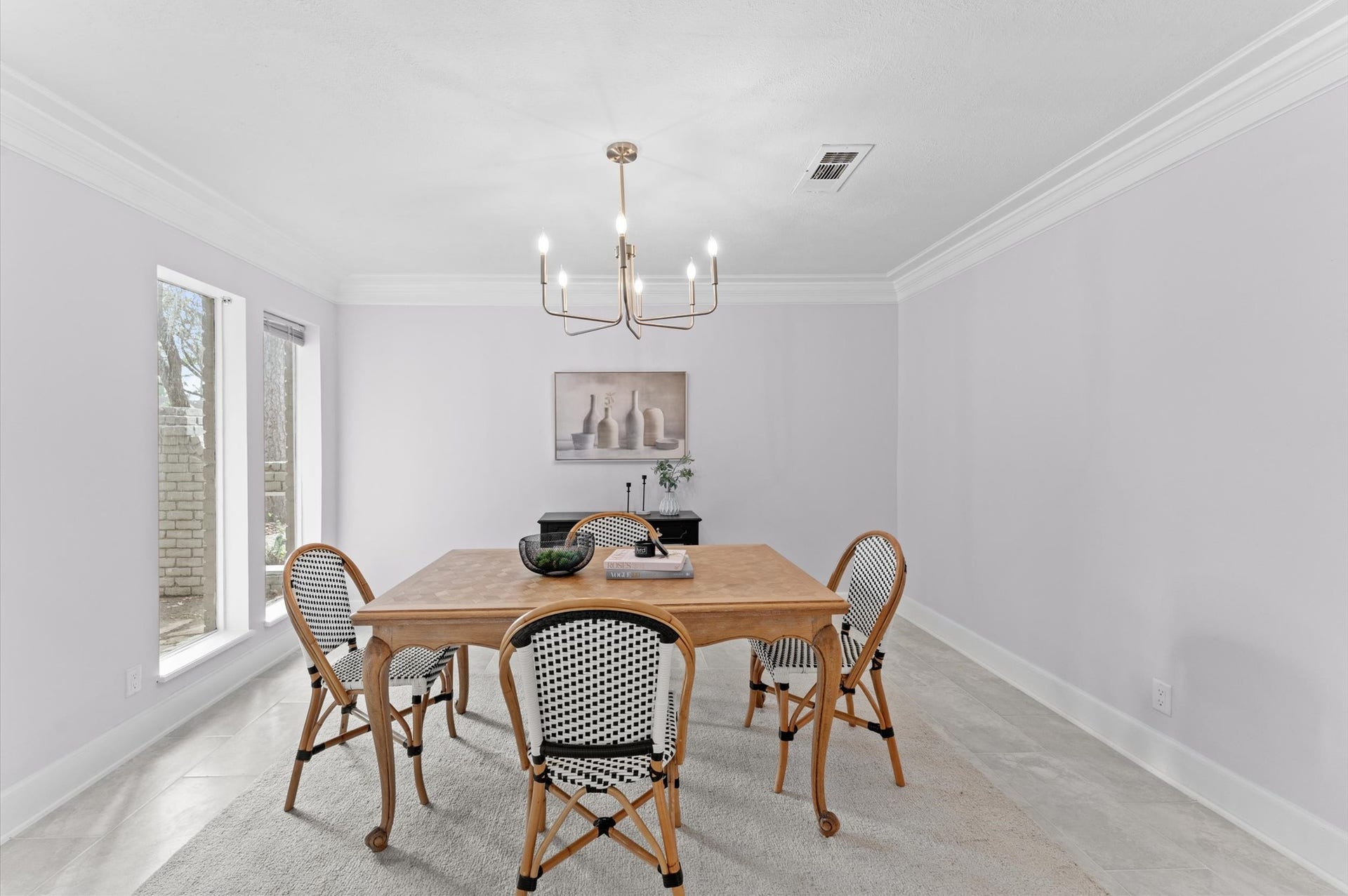 Crown molding perfectly frames the formal dining room and features elegant lighting.