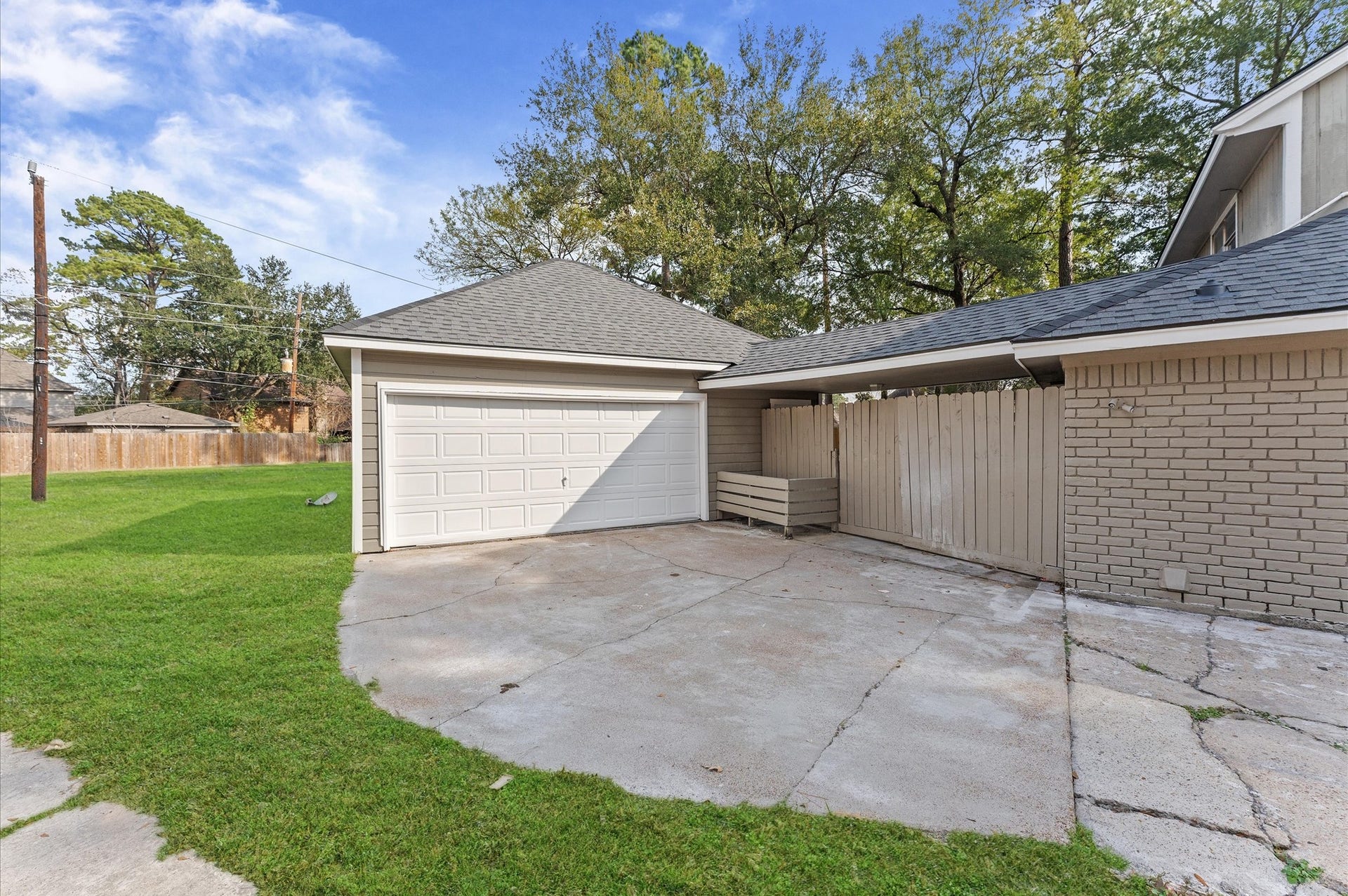 To the left of the garage is a large open area. On the right is the entry to the backyard. Notice the built-in storage bin for play equipment, barbecue equipment, or anything else you might want to store for easy access.