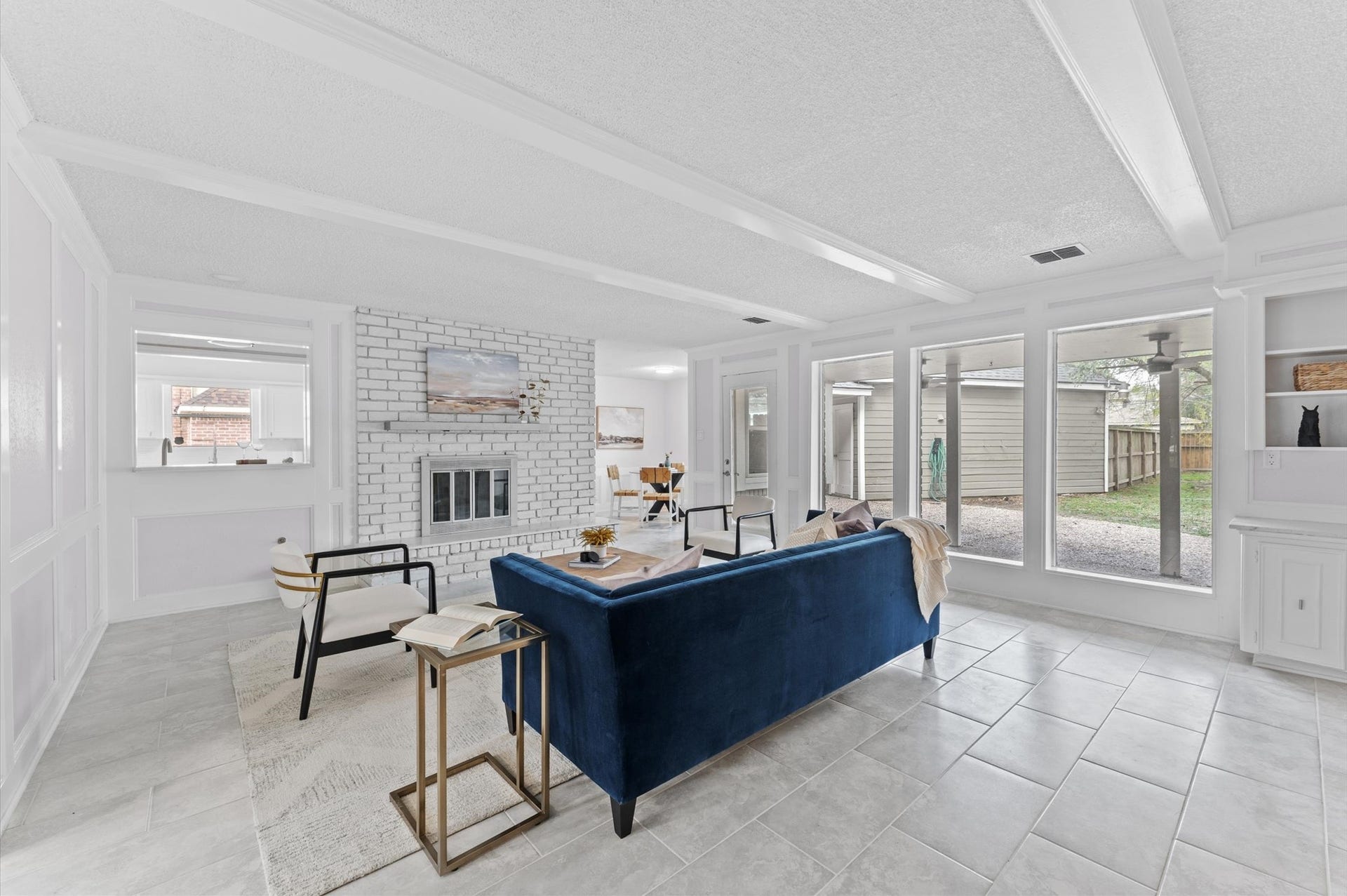 Bask in the natural light that brightens the space from all angles. Giant picture windows overlook a covered patio and backyard.