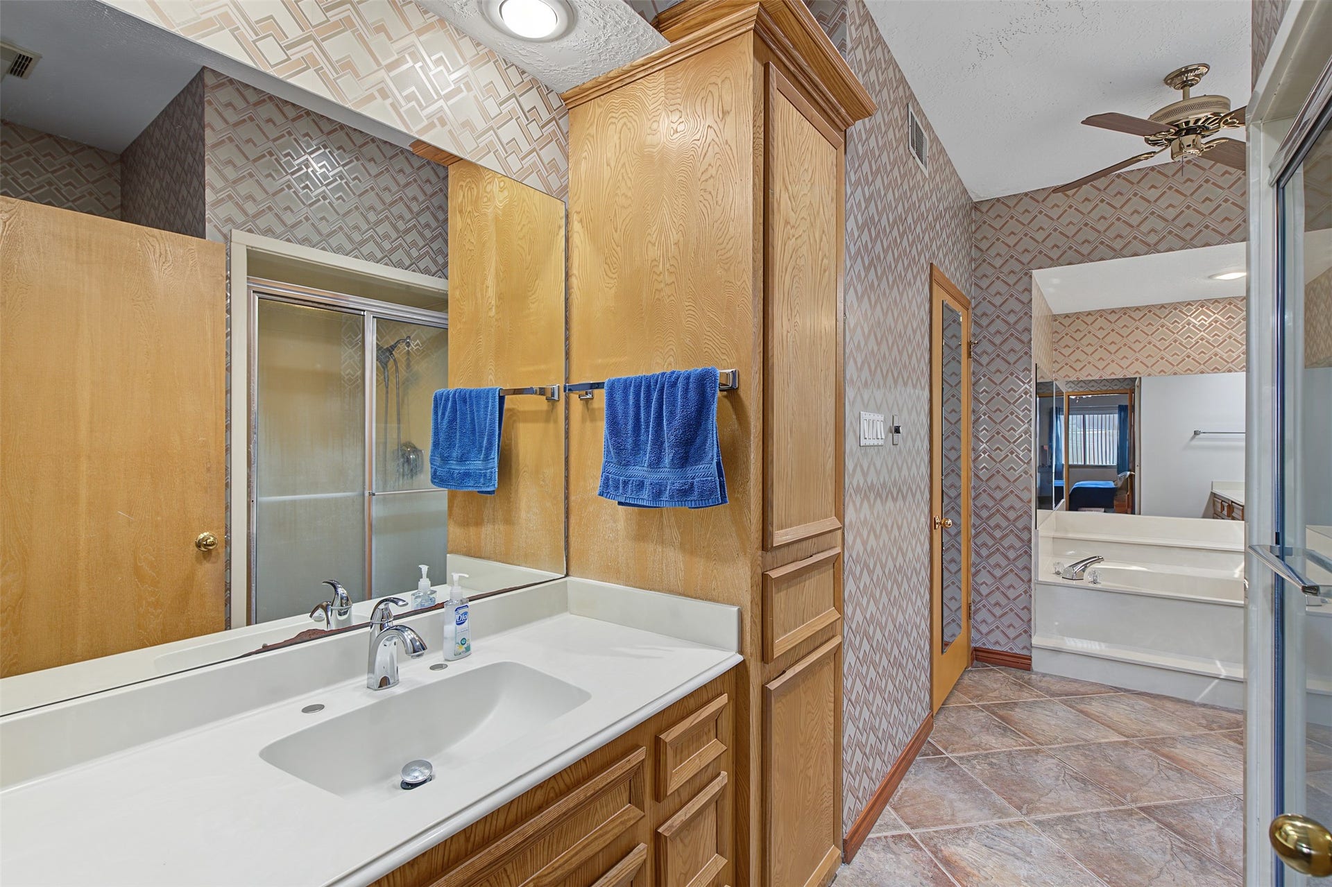 Large en-suite bathroom with double sinks and large walk in closet.