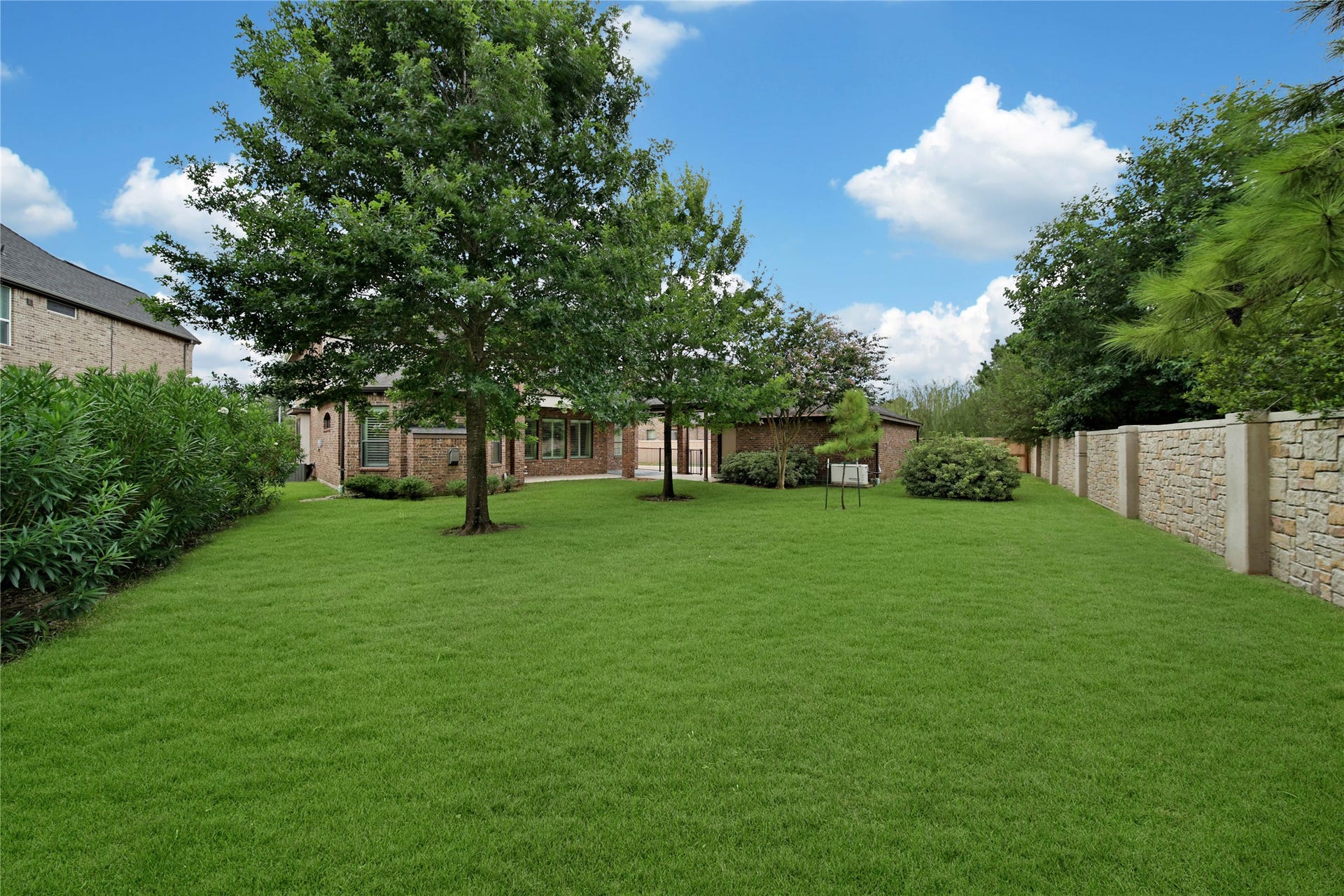 The generous pool-sized backyard features ample green space, creating a private setting with plenty of room for gatherings, pets, or future outdoor enhancements.