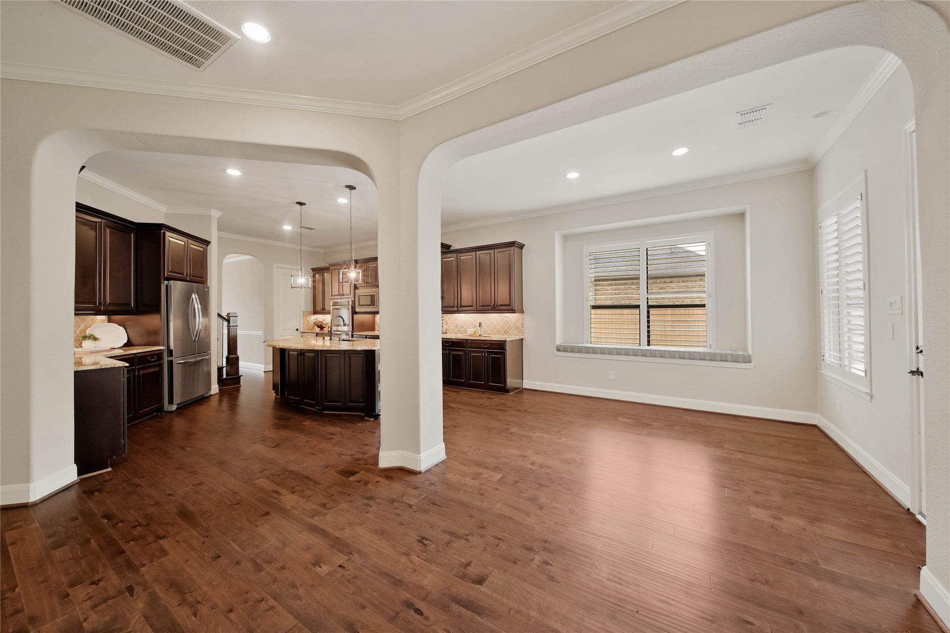 The light and bright breakfast area features a charming window with built-in bench seating, creating the perfect spot for casual meals and morning coffee.