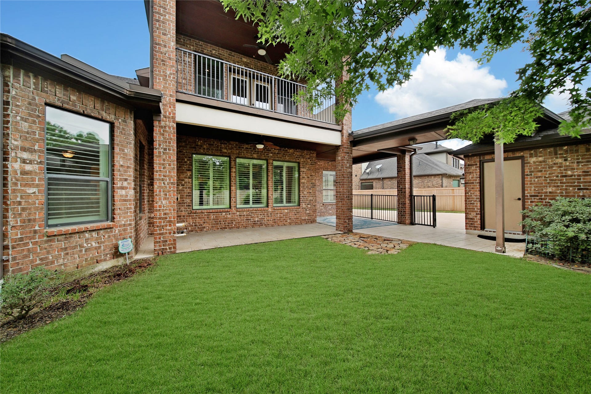 Enjoy outdoor living from two covered balconies, one on each level, offering the perfect spaces to unwind, entertain, or simply relax in the shade. The iron fence along the driveway and backyard provides a beautiful finishing touch, creating a defined outdoor space with added privacy and appeal.