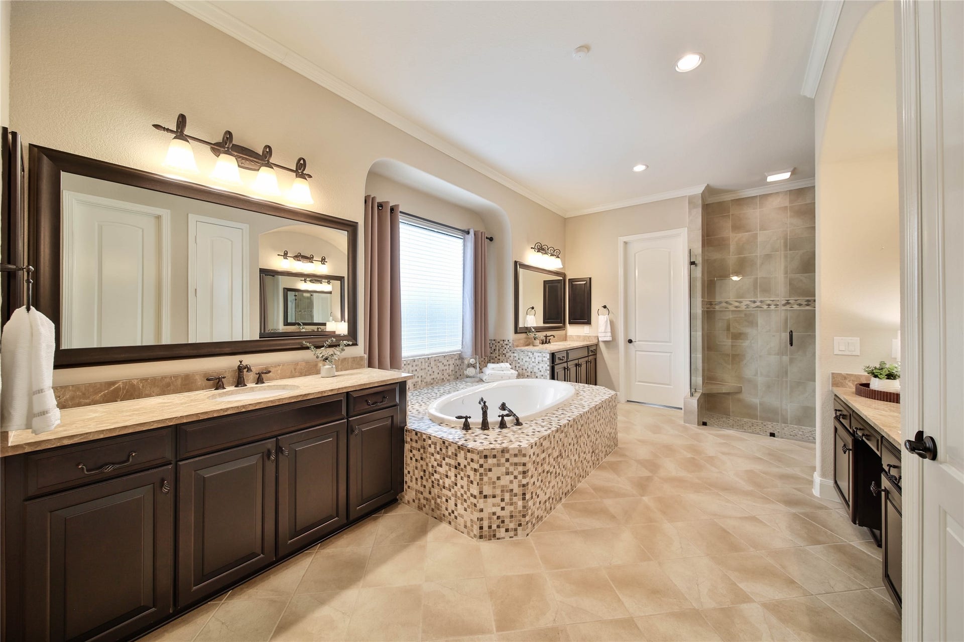 Step into the luxurious primary bath and experience a spa-inspired retreat featuring sophisticated finishes, generous space, and a calming ambiance youll love coming home to. Two spacious walk-in closets are conveniently located inside the primary bath, offering exceptional storage and easy access to your daily essentials.