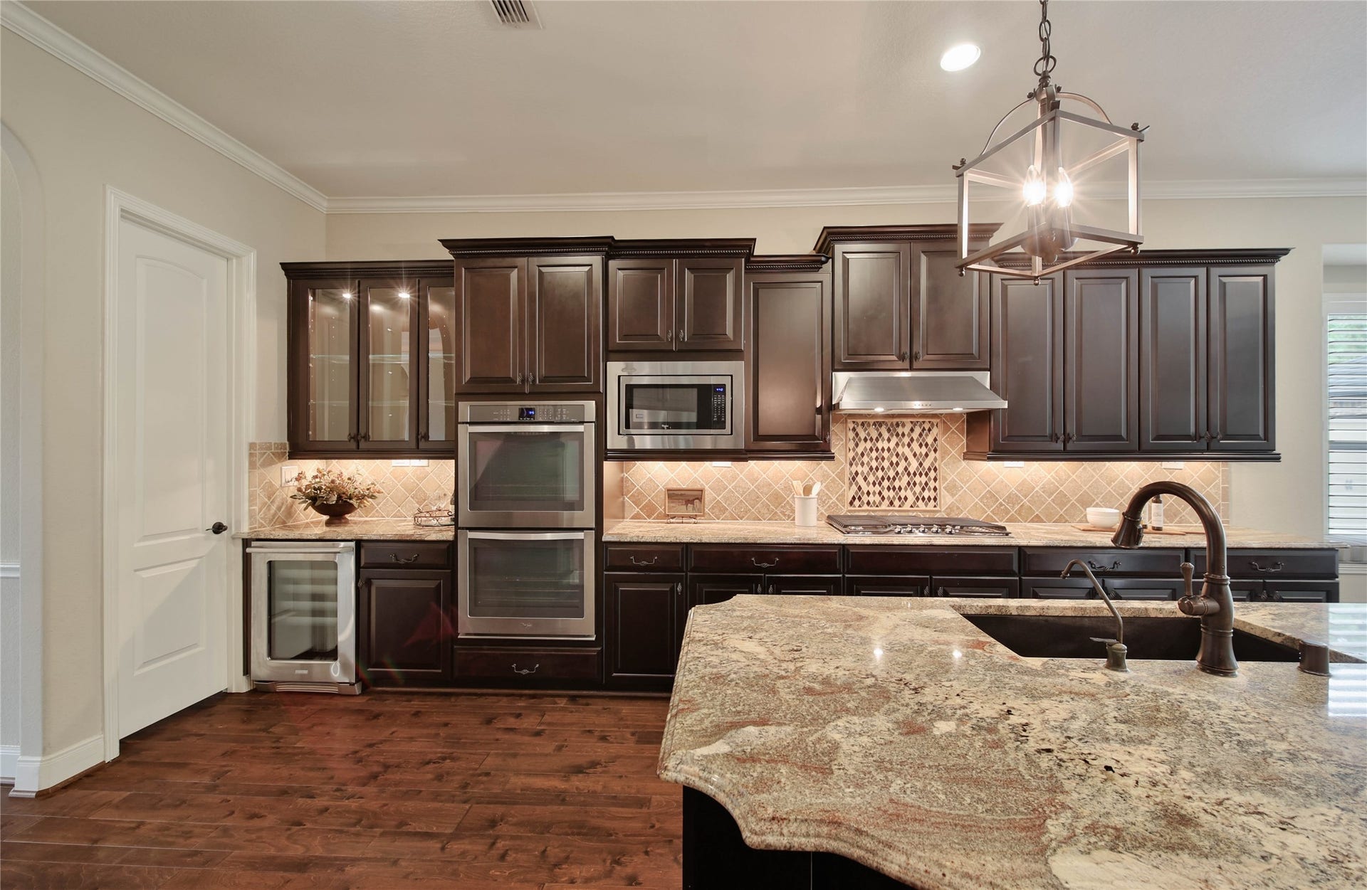 The gourmet kitchen is beautifully appointed with a full suite of stainless steel Whirlpool appliances, including double ovens, creating the perfect space for everyday cooking and entertaining.