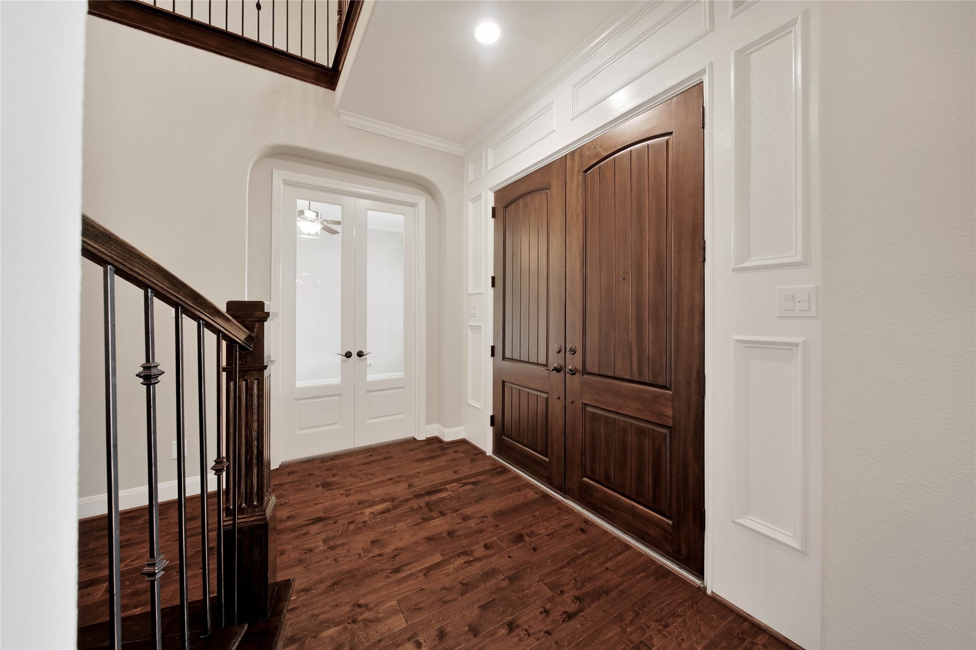 The grand entry, highlighted by soaring ceilings and rich wood floors, makes an unforgettable first impression.