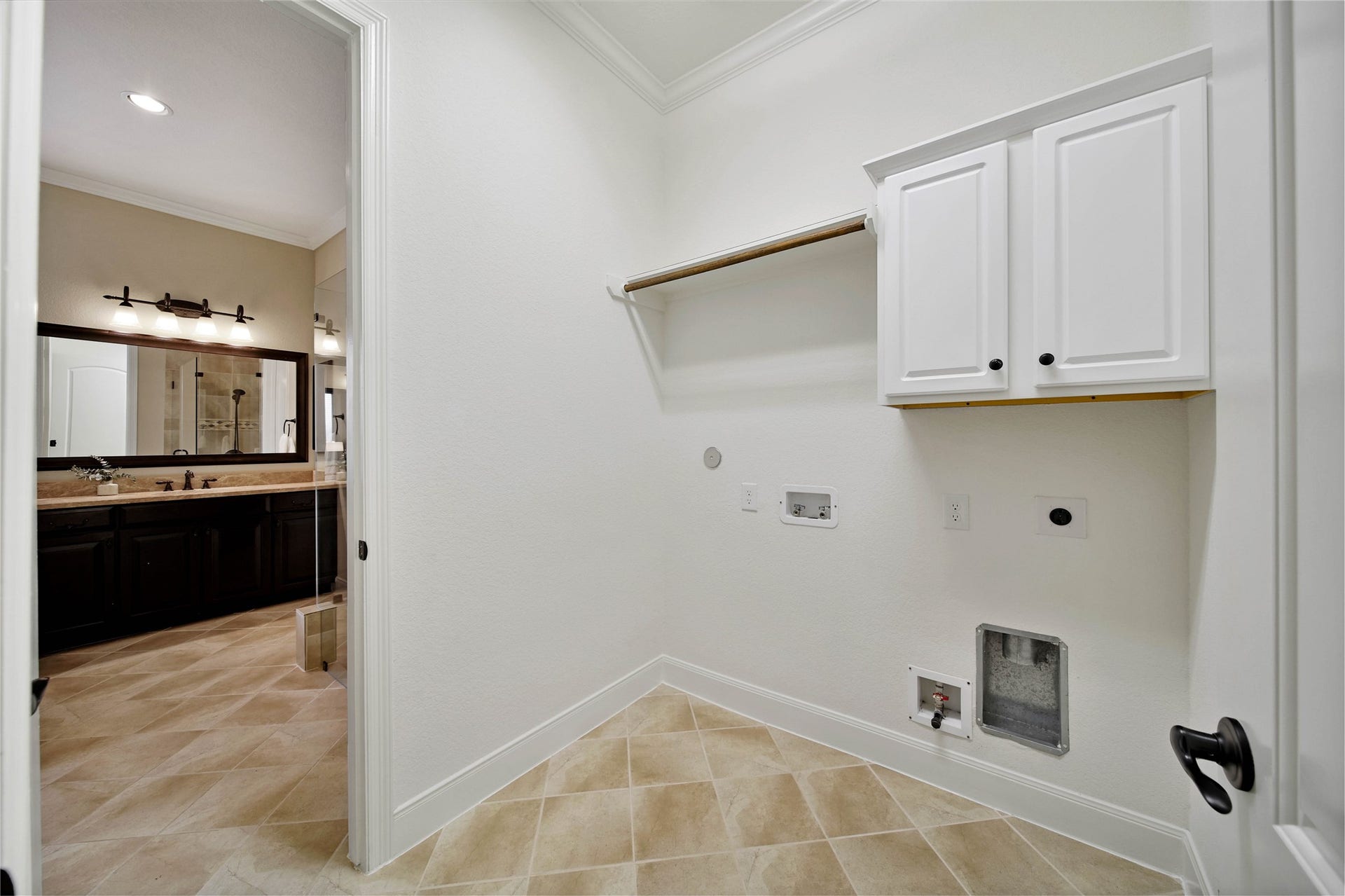 The attached utility room makes everyday living easier with direct access from the primary bath and the added flexibility of both gas and electric dryer hookups.