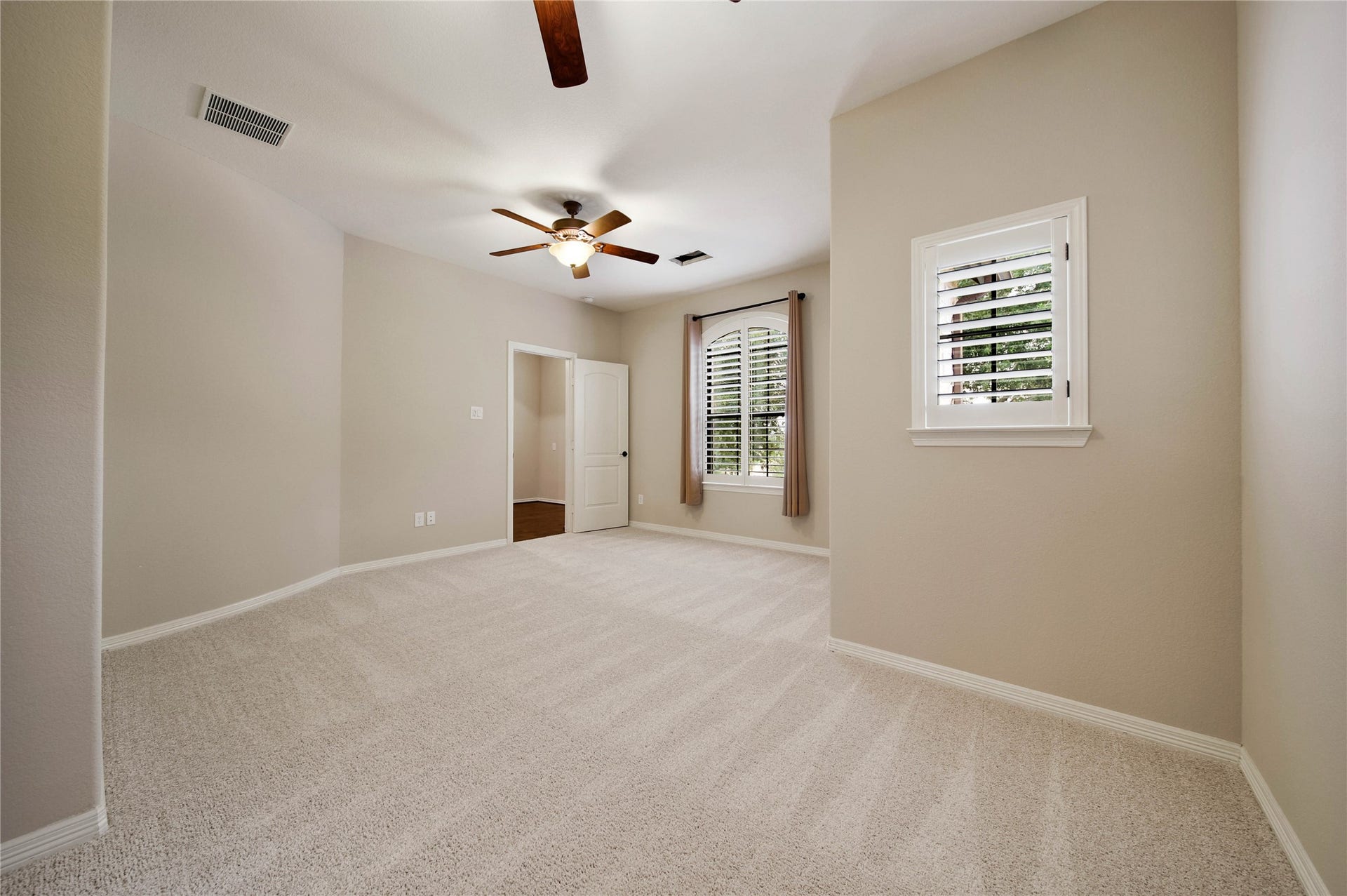 Every secondary bedroom is designed with comfort in mind, featuring shutters, spacious walk-in closets, and ceiling fans (this one has two!)