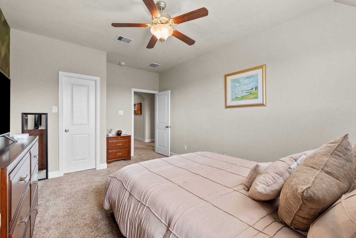 416 Via Regatta Drive, Webster, TX 77598 The room is flooded with natural light from a large window and boasts a bright ceiling with a central multi-speed fan and integrated light kit.
