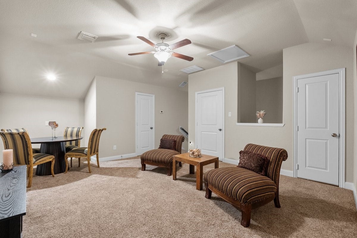 416 Via Regatta Drive, Webster, TX 77598 Ascend to the third level to discover a massive, private 15x15 game room or media retreat designed for ultimate versatility. This expansive bonus space features soft, clean carpeting, a central ceiling fan, and a deep tray ceiling layout that adds an extra layer of architectural volume.
Wired for your entertainment setup, this floor operates as its own self-contained getaway, complete with a convenient, custom-painted half bath. Whether used as a high-tech home theater, a quiet executive office, a fitness