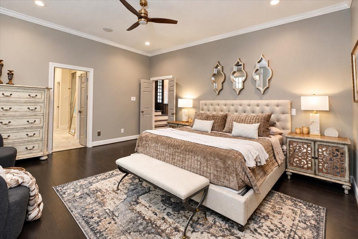 14026 Champions Hamlet Court, Houston, TX 77069 An elegant place to start and end each day. Dark hardwood floors, soft neutral walls, and a main-level location make this primary suite as practical as it is beautiful, with the bedroom already wired for your TV.