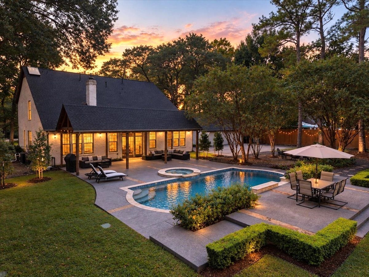 14026 Champions Hamlet Court, Houston, TX 77069 Resort-inspired outdoor living at home. The sparkling pool and hot tub, redone in 2024 with new tile, coping, and equipment, are surrounded by a flagstone-accented deck. The mature trees and glowing evening light make every night feel like a getaway.