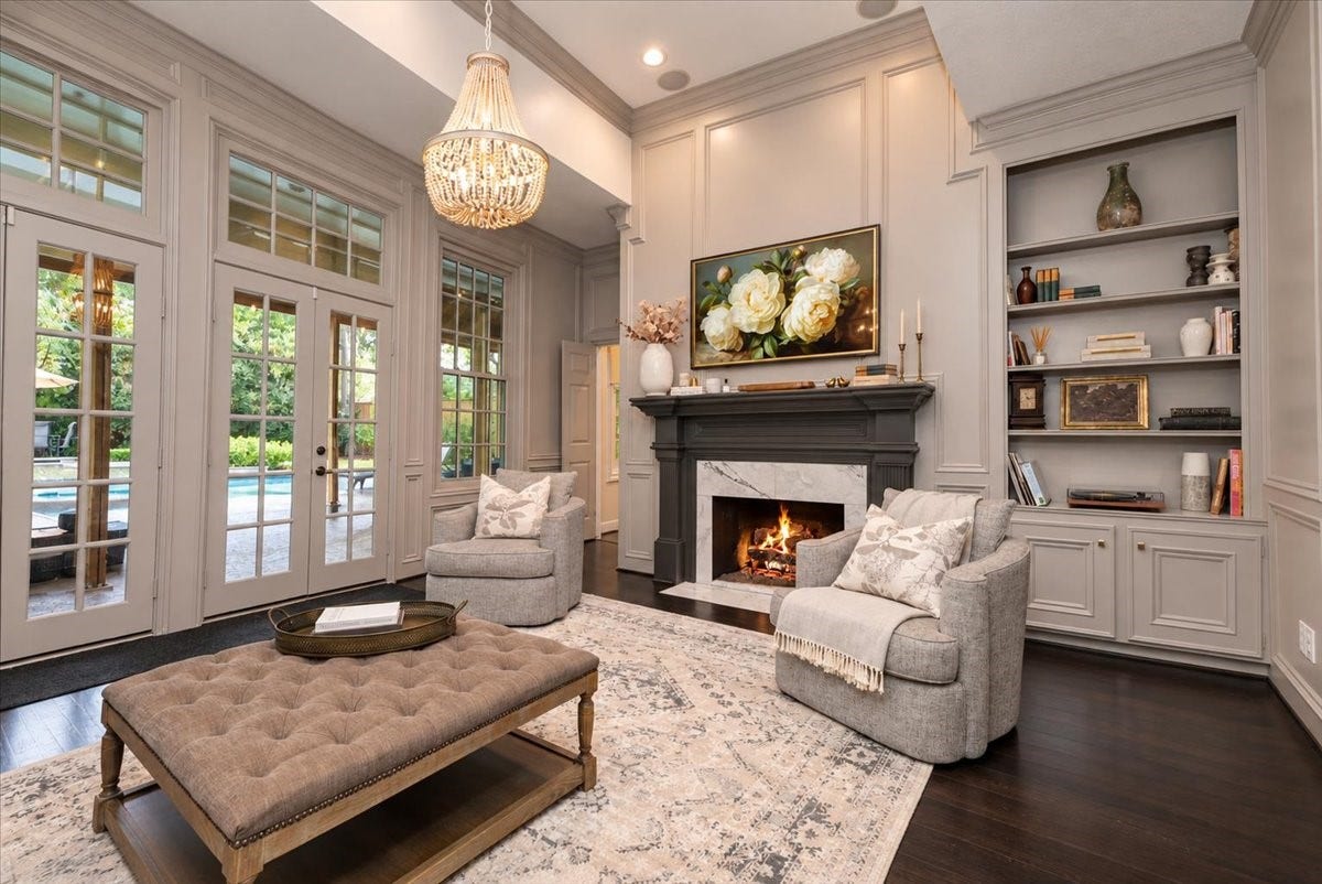 14026 Champions Hamlet Court, Houston, TX 77069 Made for entertaining and everyday comfort, this spacious living room has room for large gatherings, an elegant fireplace mantel to anchor the space, and French doors that lead straight out to the covered patio and pool.