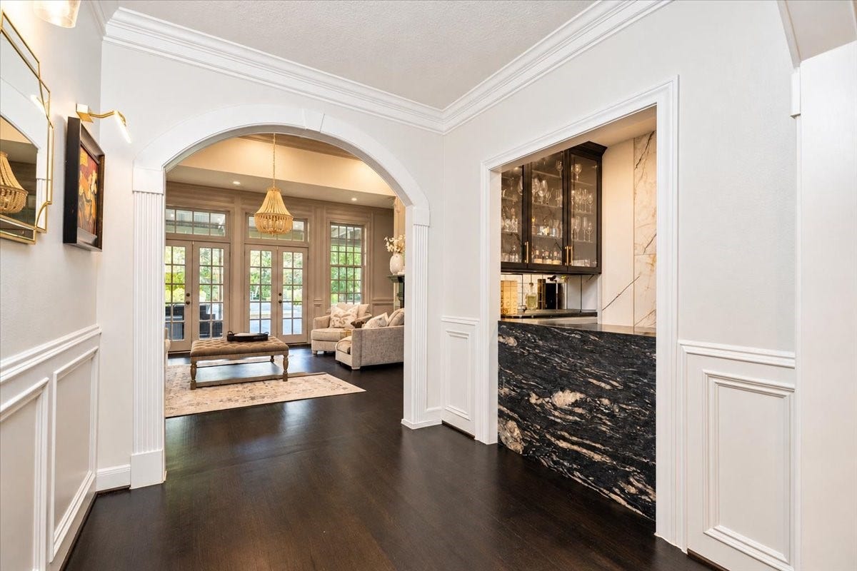 14026 Champions Hamlet Court, Houston, TX 77069 A custom bar sits off the foyer, with an arched entry leading into the living room and out to the pool and patio.