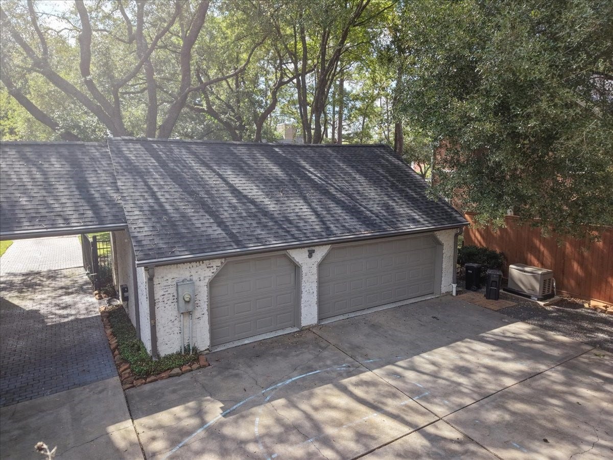14026 Champions Hamlet Court, Houston, TX 77069 Inside, this garage has custom cabinets for storage and durable epoxy floors (2023), and the paver drive and porte cochere make coming and going easy and covered.