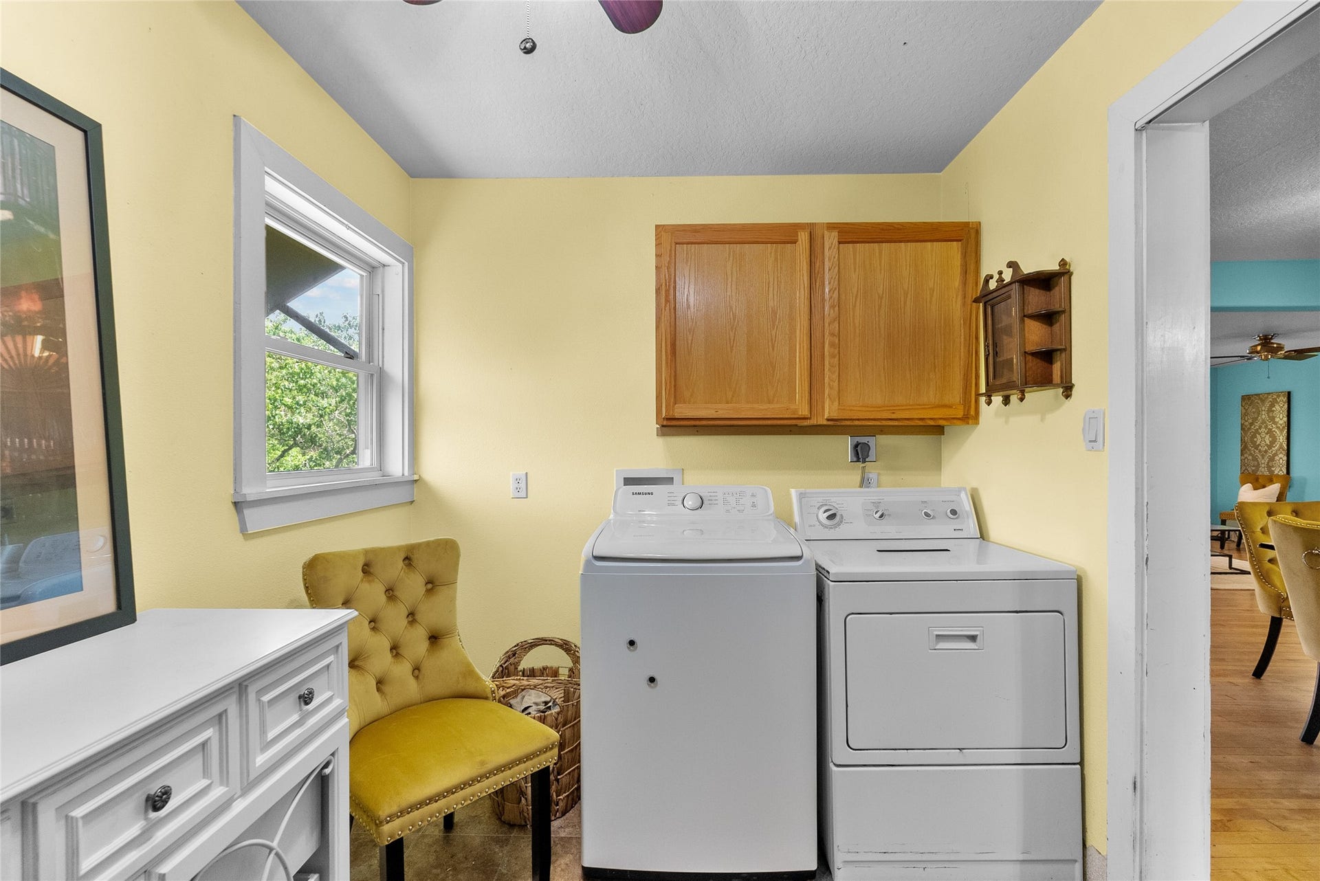 939 17th Street, Dickinson, TX 77539 Dedicated laundry room with full-size washer and dryer connections, upper cabinetry, natural light and additional space for storage or organization