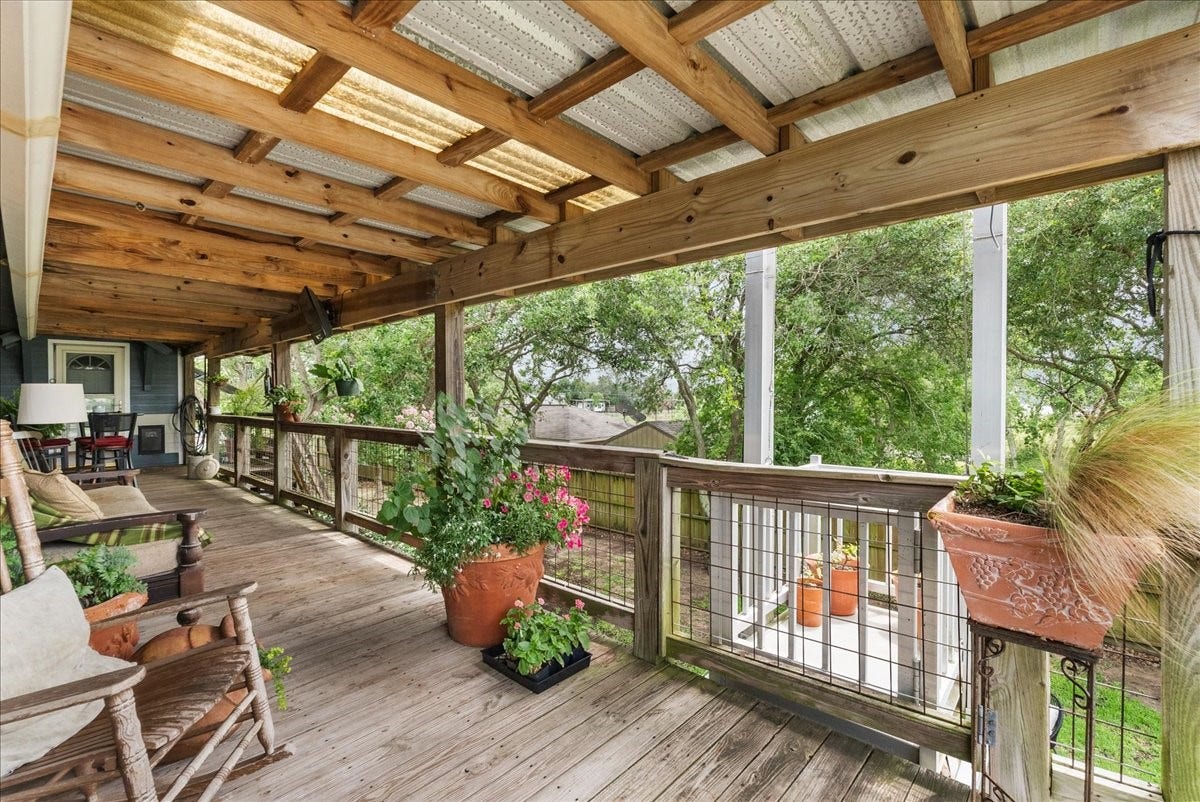 939 17th Street, Dickinson, TX 77539 Expansive covered deck provides a shaded outdoor living space surrounded by mature trees that's ideal for relaxing, dining or entertaining