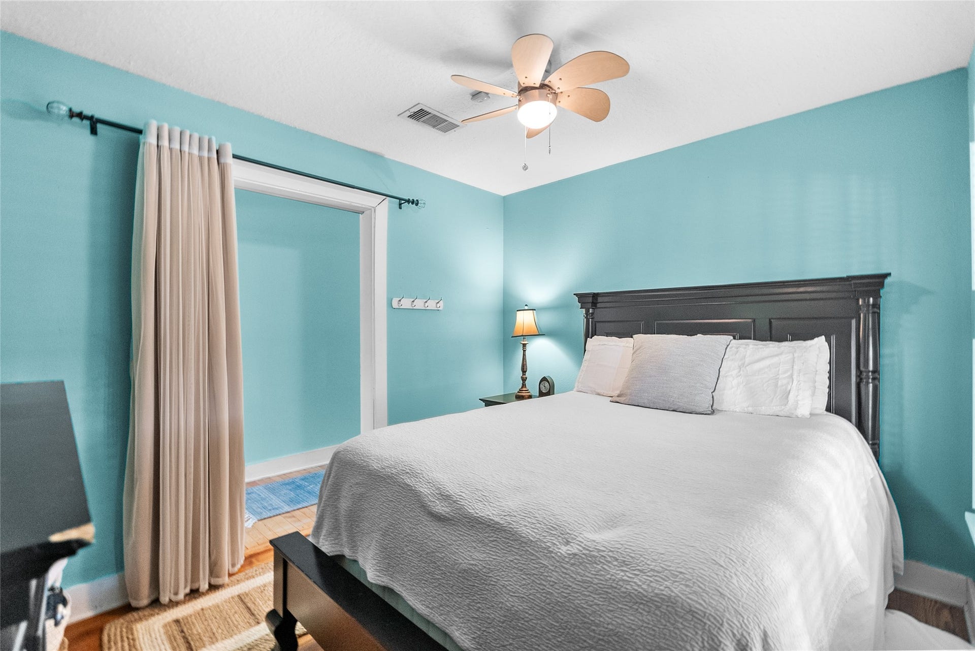939 17th Street, Dickinson, TX 77539 Comfortable secondary bedroom with hardwood flooring and an adjacent bonus area that offers additional flexibility
