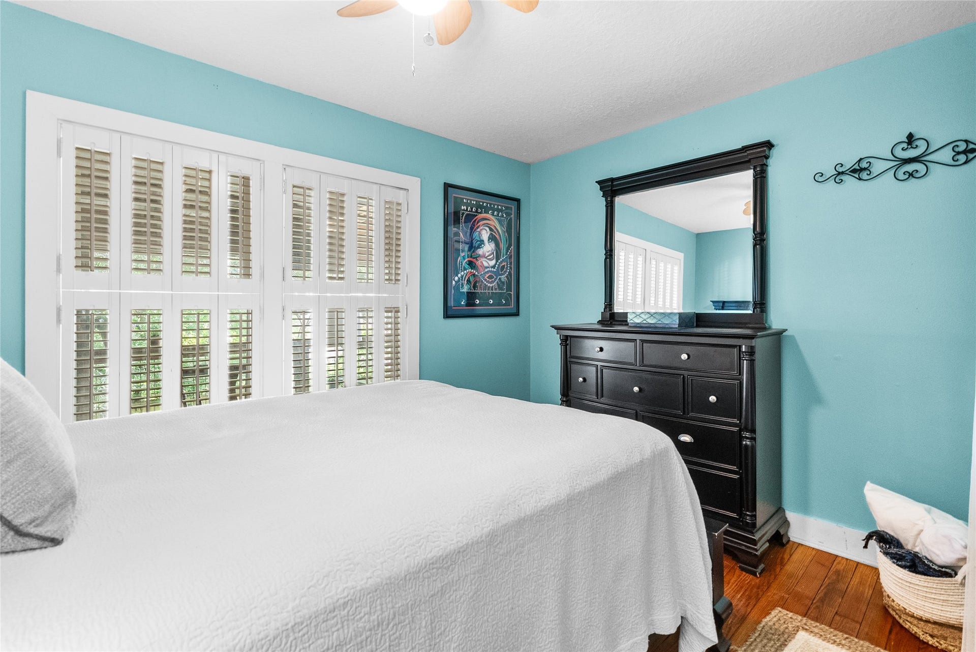 939 17th Street, Dickinson, TX 77539 Secondary bedroom with hardwood flooring, plantation shutters and generous natural light