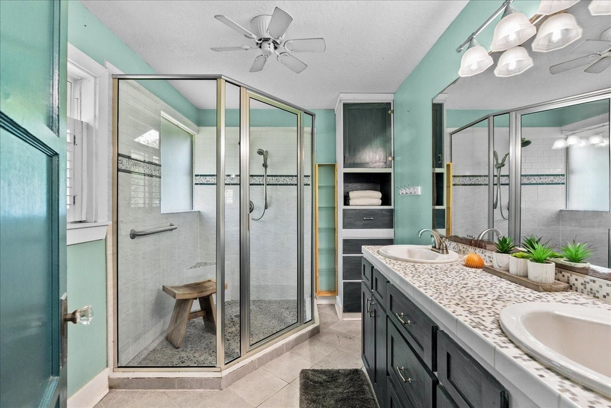 939 17th Street, Dickinson, TX 77539 Primary bathroom features a dual-sink vanity, generous counter space, extensive cabinetry and an adjoining shower area