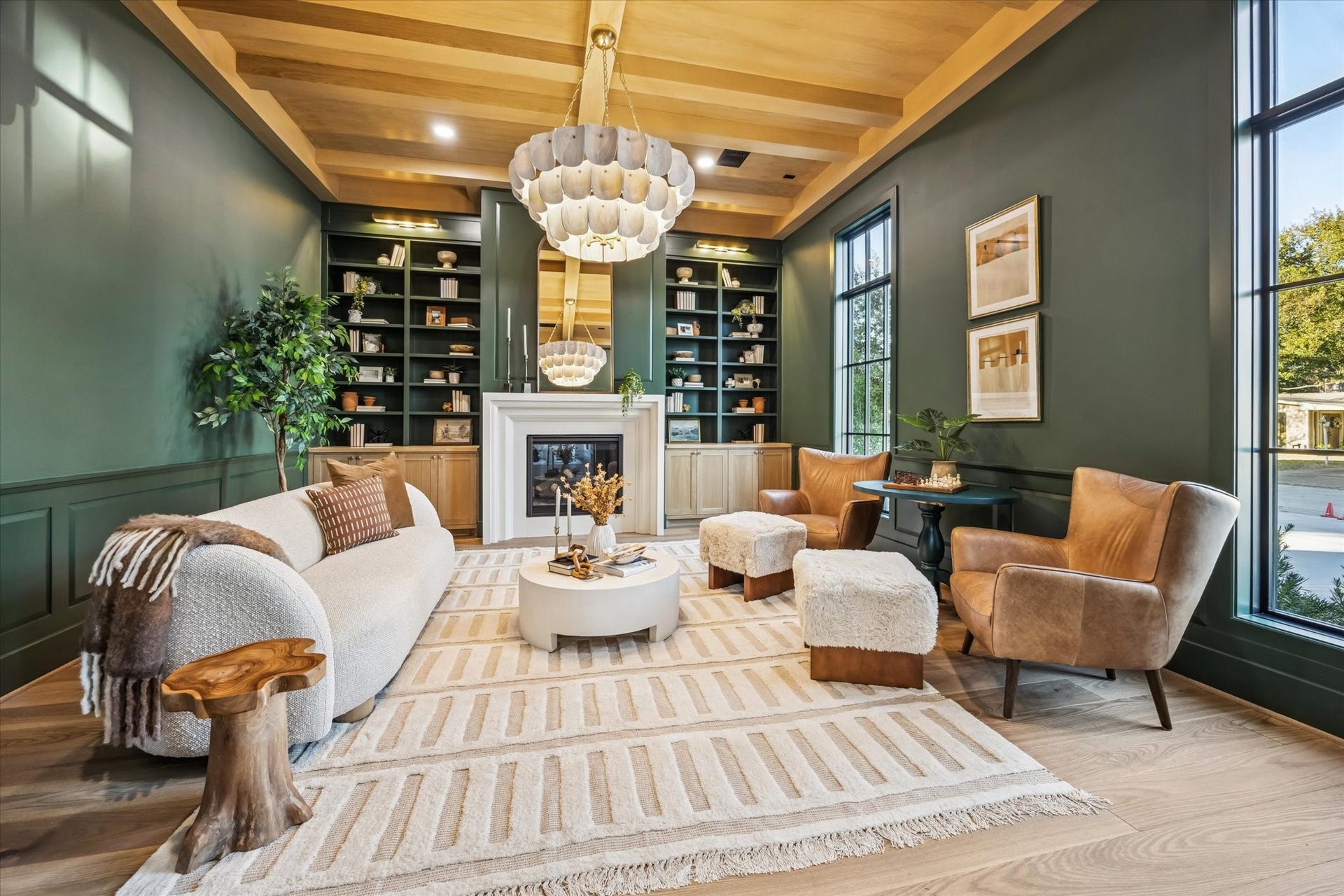 Coffered wood ceiling, full height custom built ins, and a centered fireplace establish this space as a true flex room suited for a private office, library, or formal sitting room. Tall windows and layered lighting bring in natural light while maintaining a quiet separation from the main living areas. **Previous build by Arch Angelo**