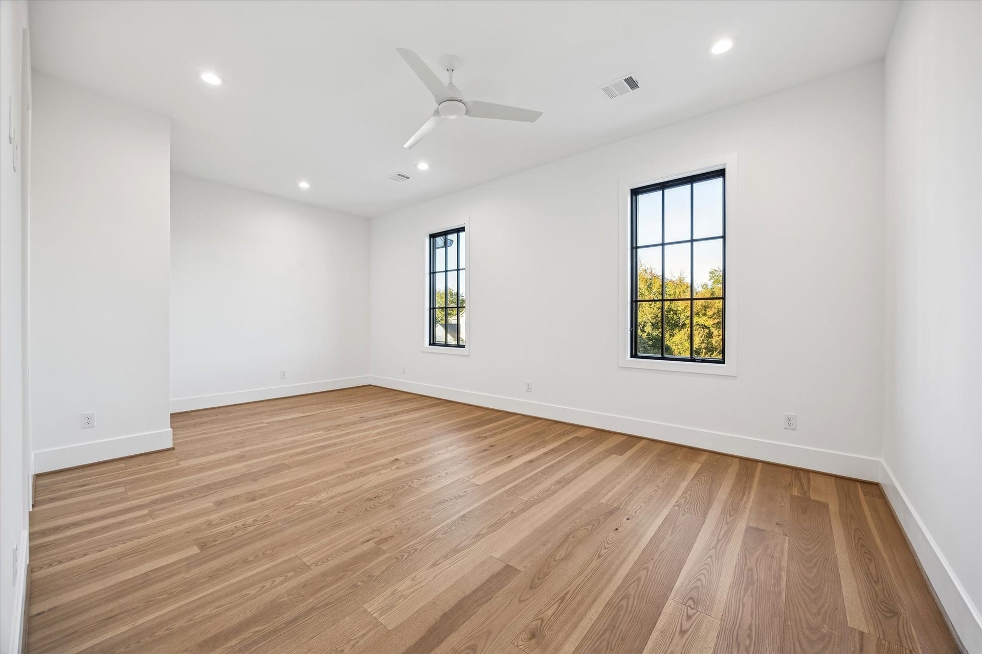 Natural light and generous floor space make this secondary bedroom easy to adapt for guests, family, or a home office. Clean lines and a neutral palette allow for flexibility without sacrificing comfort. **Previous build by Arch Angelo**