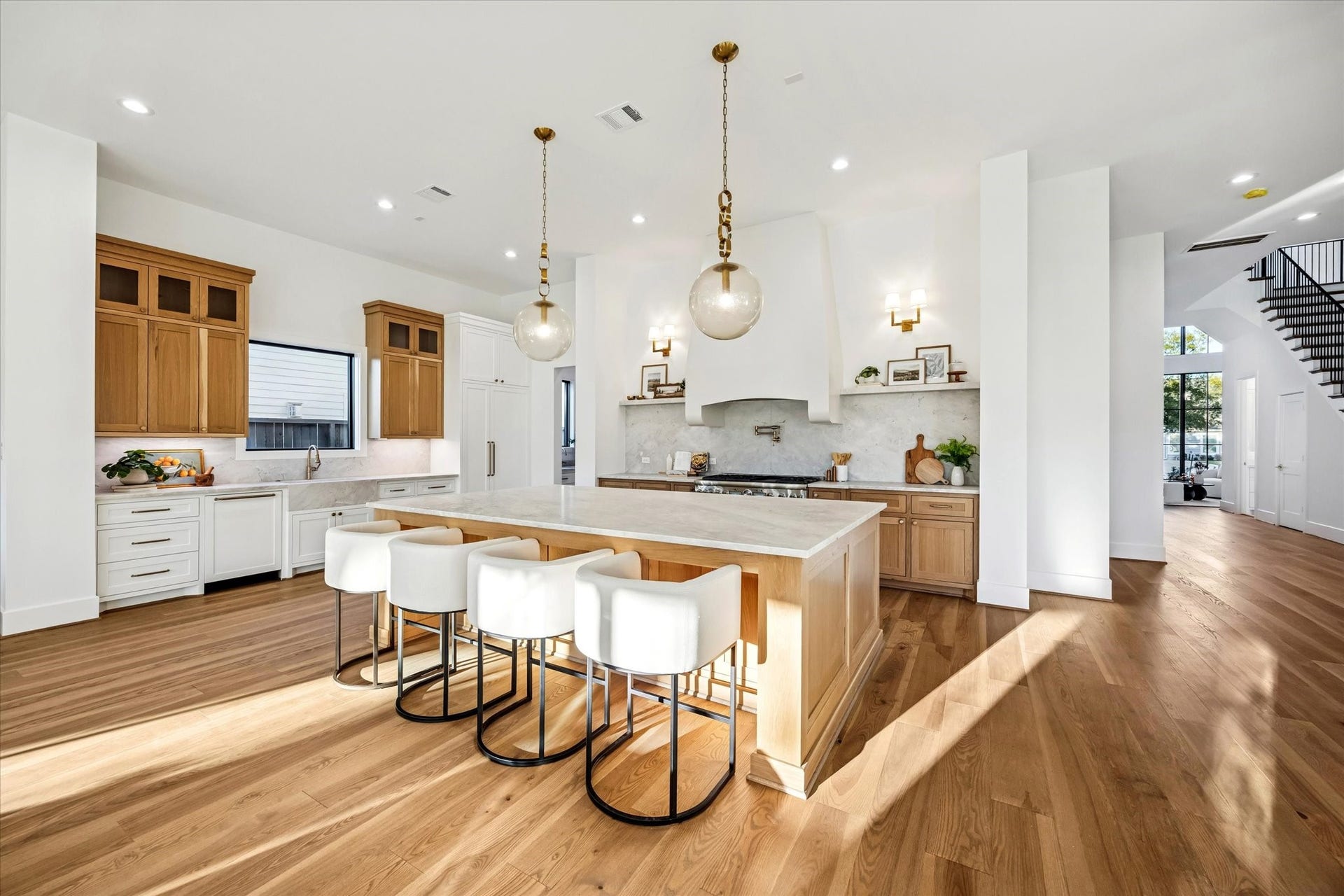Expansive kitchen anchors the main living level with a generous island, abundant counter space, and clear sightlines to surrounding rooms. Designed for both daily use and entertaining, the layout supports multiple work zones without crowding or interruption. **Previous build by Arch Angelo**