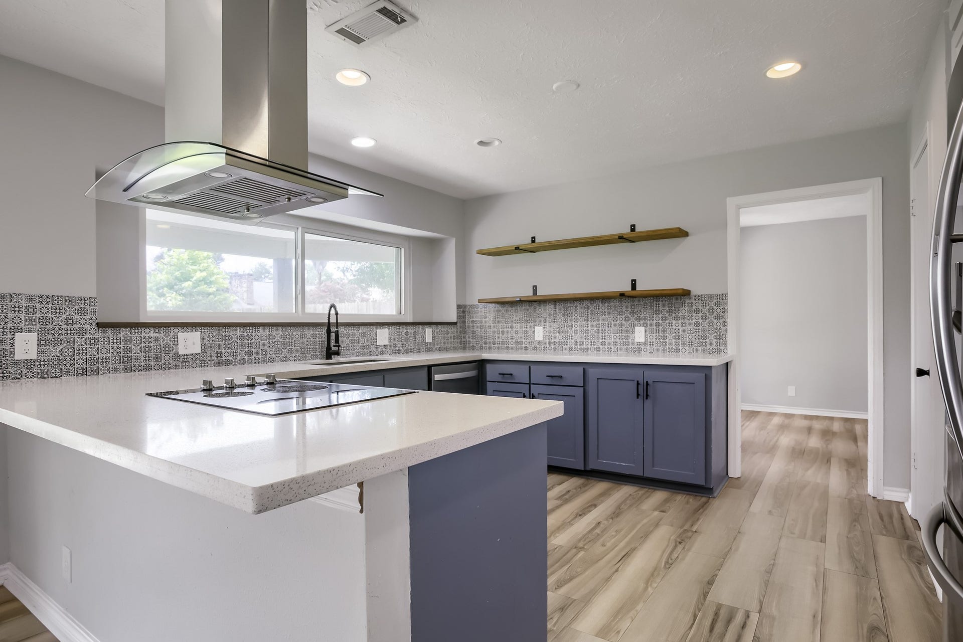 16505 Cornwall Street, Jersey Village, TX 77040 Sleek kitchen view from the dining area, featuring modern finishes and ample natural light.