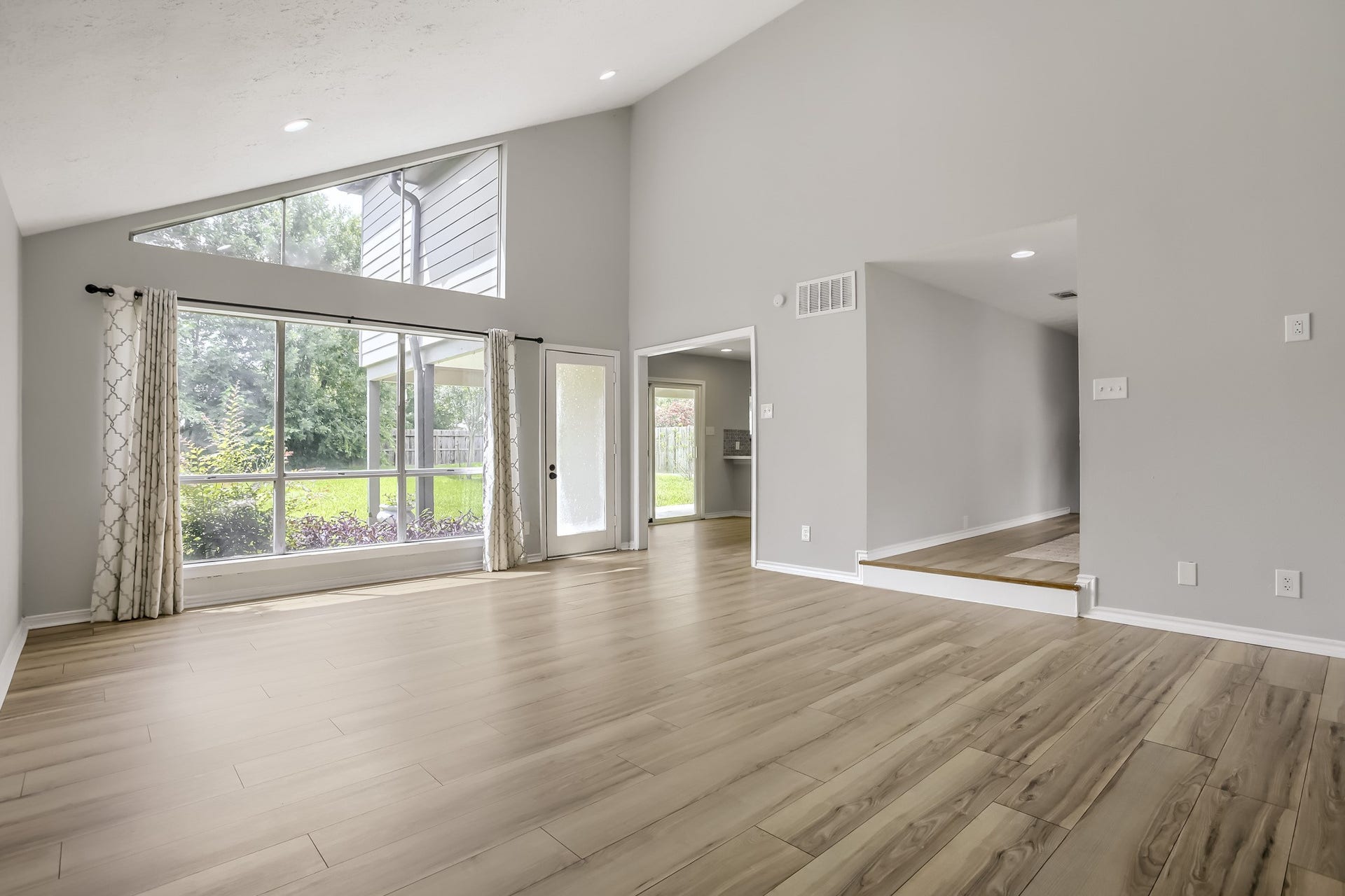 16505 Cornwall Street, Jersey Village, TX 77040 Bright den with large windows overlooking the backyard, seamlessly connecting to the kitchen.