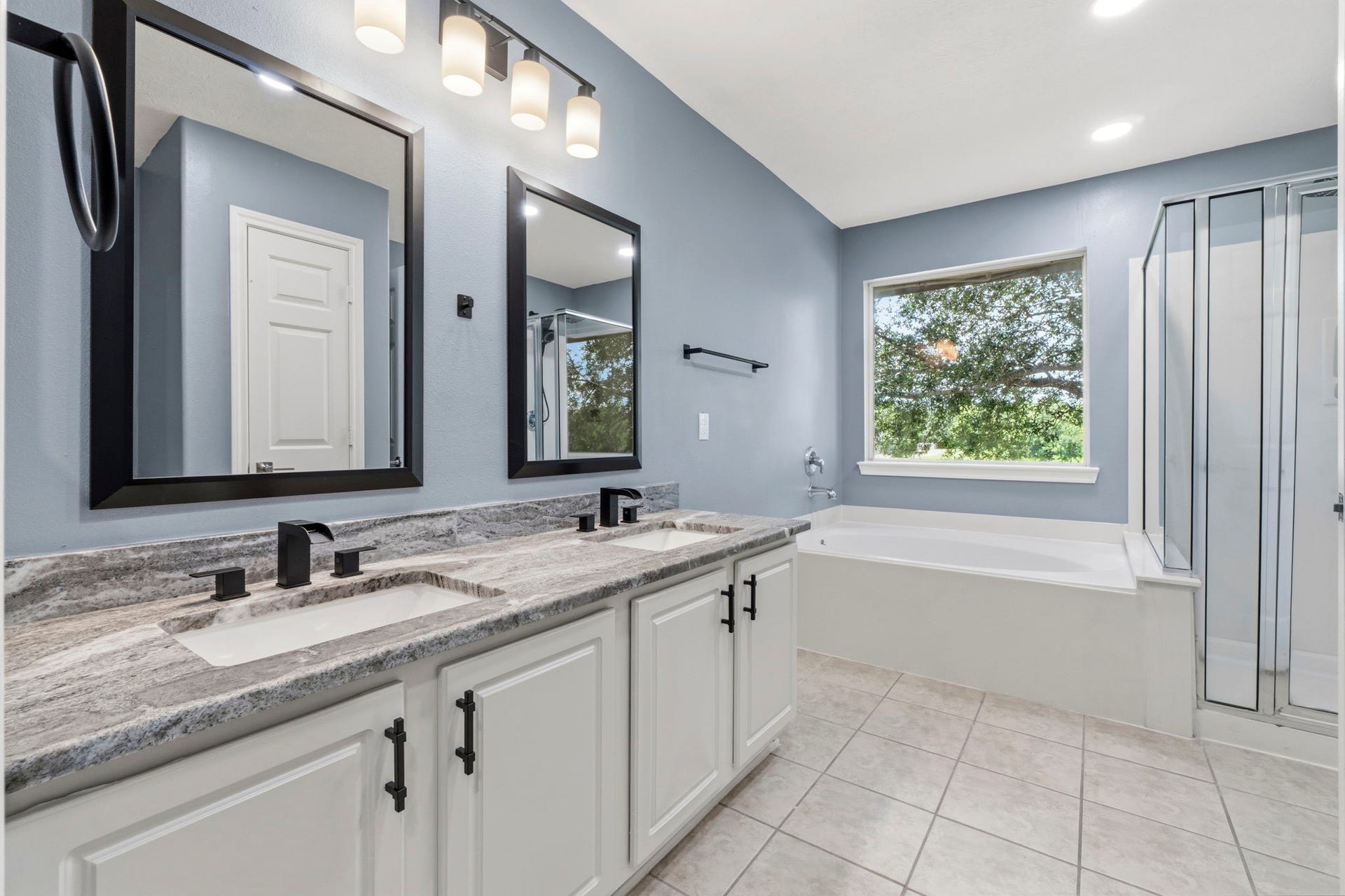 238 Drake Run Lane, Dickinson, TX 77539 Freshly painted cabinets, modern faucets and light fixtures