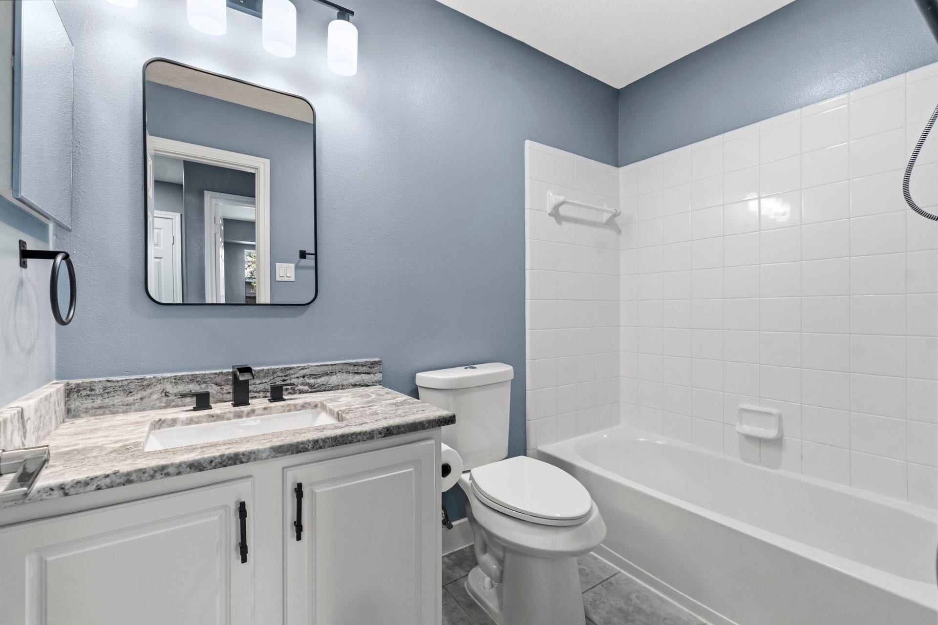 238 Drake Run Lane, Dickinson, TX 77539 Secondary bath features granite countertops, elongated commode, designer mirror, new painted cabinets
