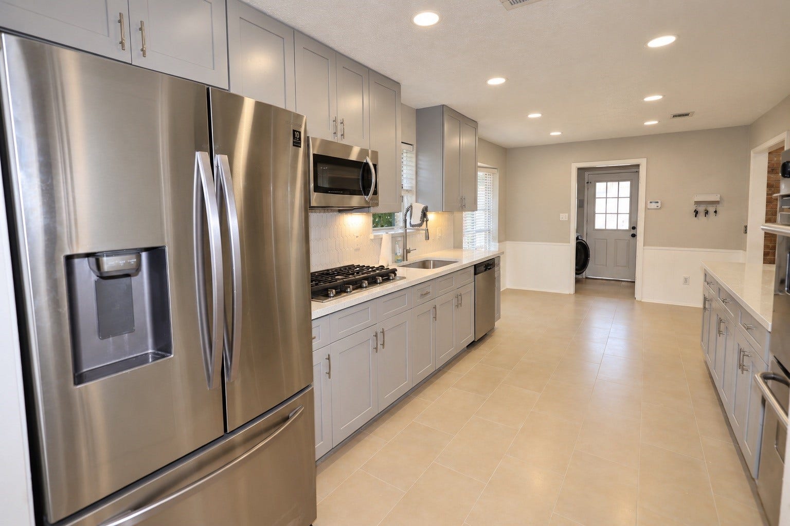 12034 Meadowdale Drive, Meadows Place, TX 77477 Alternate view of the kitchen includes a refrigerator and a gas cooktop
