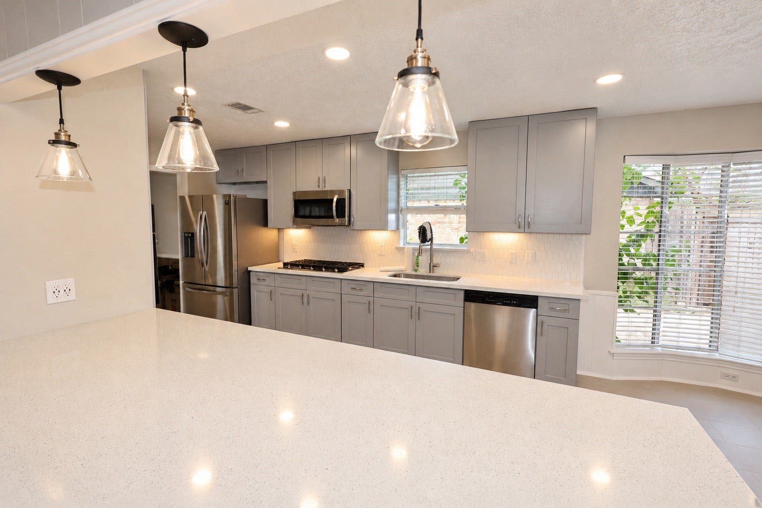 12034 Meadowdale Drive, Meadows Place, TX 77477 This kitchen has been fully renovated and features modern finishes, complemented by a large bar that provides ample counter space