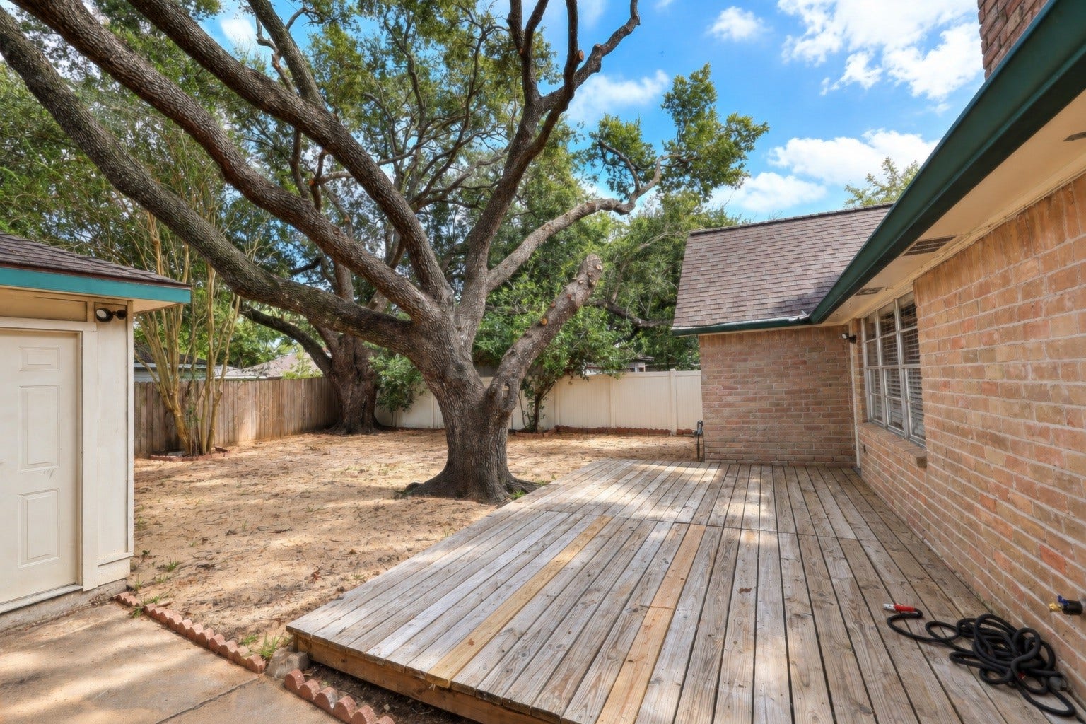12034 Meadowdale Drive, Meadows Place, TX 77477 Fully fenced backyard features a large oak tree, a spacious patio and lots of space for entertaining