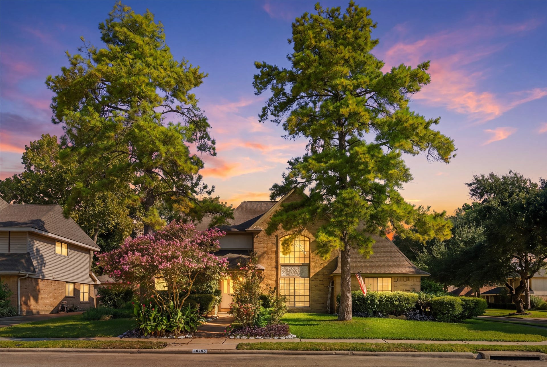 A charming brick residence framed by mature trees and beautifully landscaped gardens creates an inviting first impression, giving buyers the feeling of coming home to a peaceful, established neighborhood.
