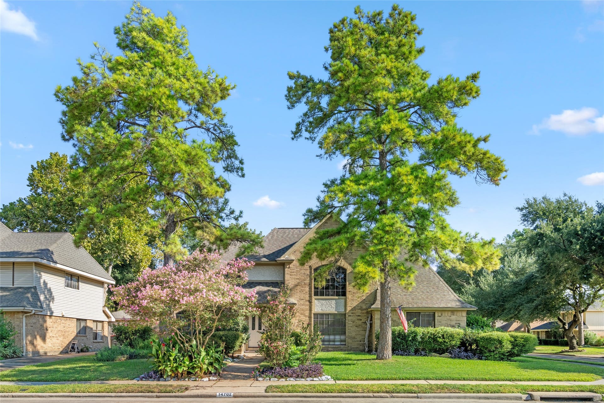 The two-story brick design, mature shade trees, and established landscaping give this home timeless curb appeal and a welcoming presence from the street.