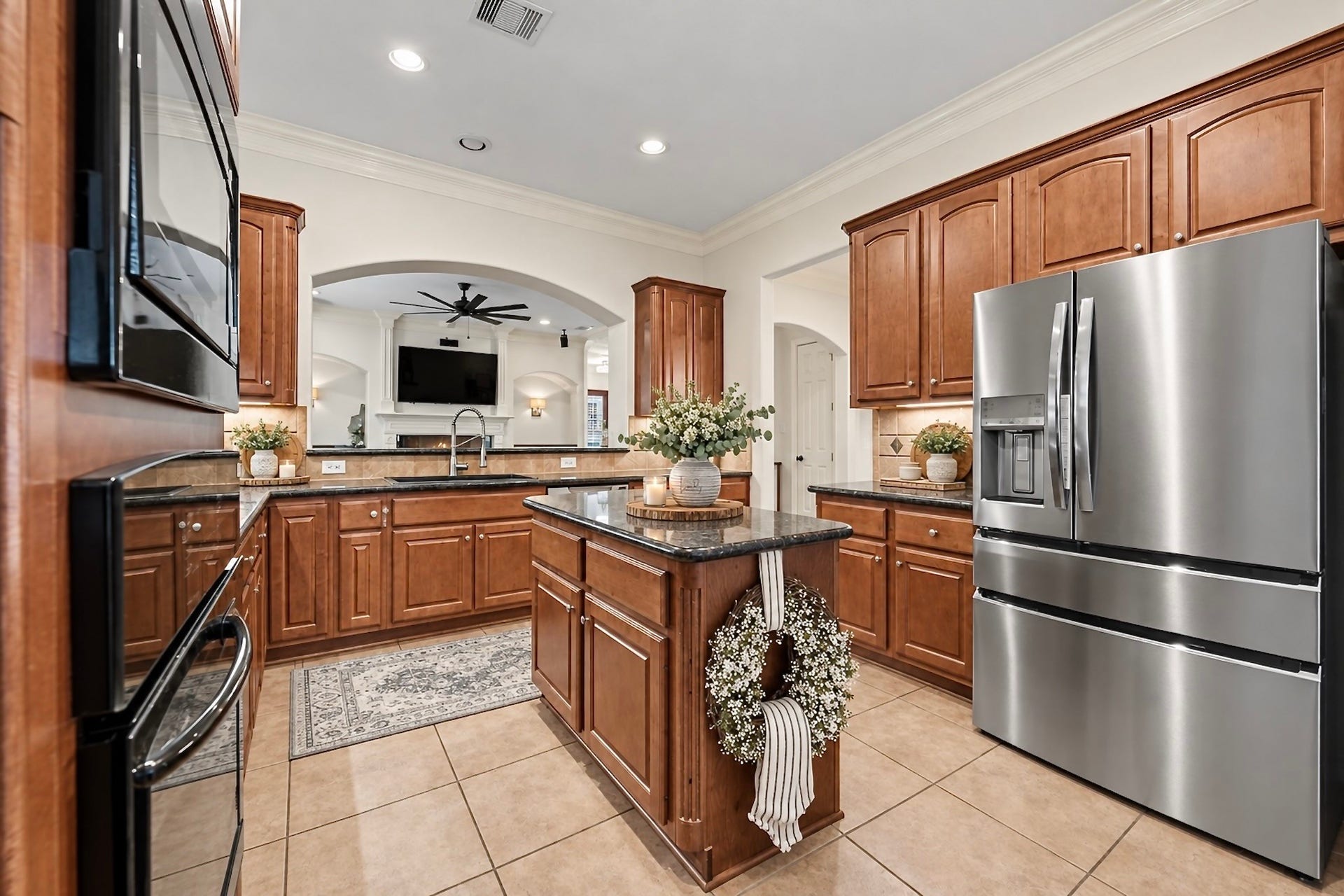 Stylish kitchen with granite countertops, stainless steel appliances, generous cabinetry, and breakfast bar. Virtually staged for inspiration.