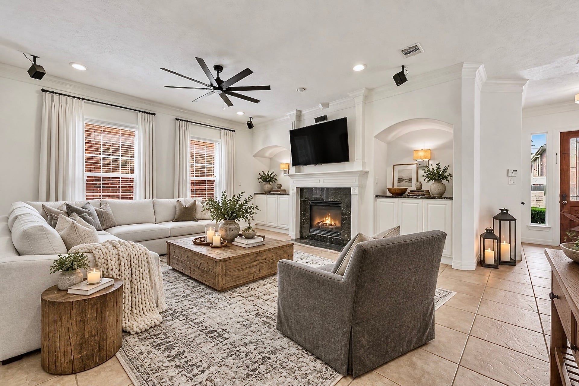 Inviting living room with fireplace, built-in cabinetry, and abundant natural light.
