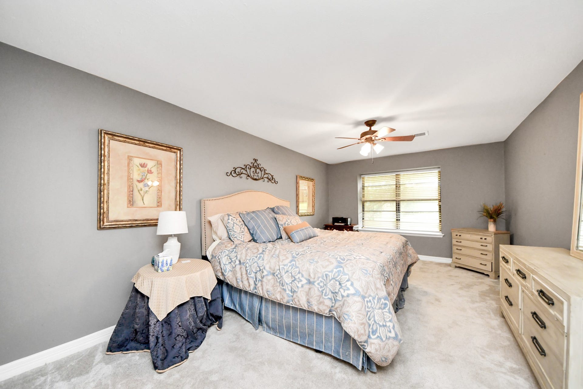 1710 Mayweather Lane, Richmond, TX 77406 Spacious primary suite with neutral finishes, updated carpet, and views of the backyard.