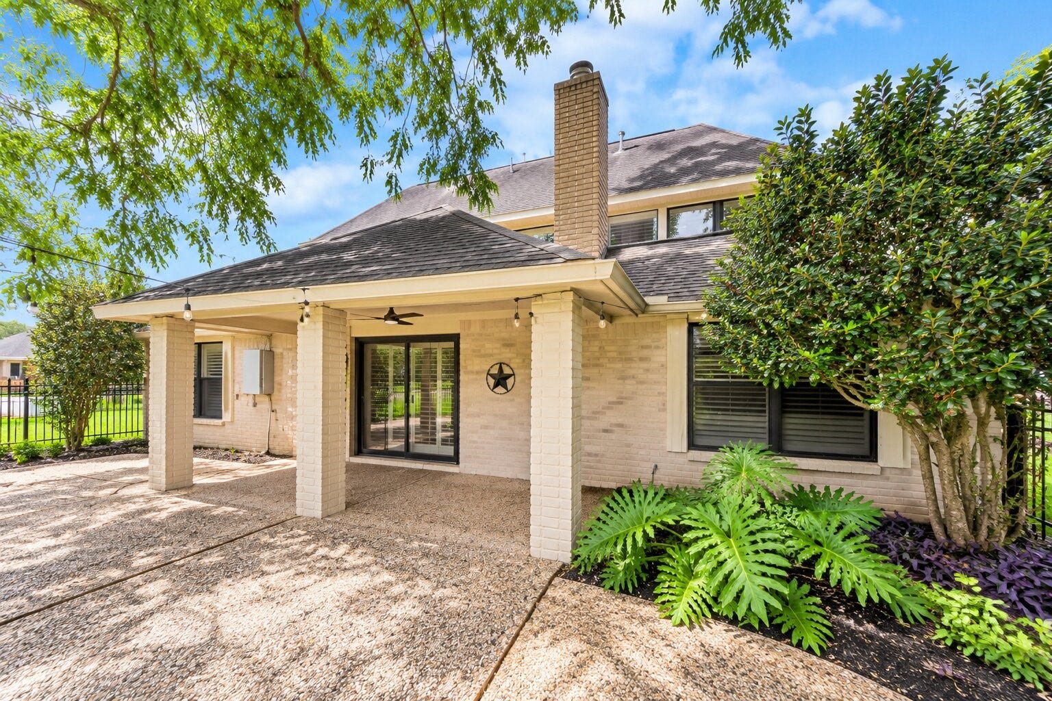 1710 Mayweather Lane, Richmond, TX 77406 Rear exterior features a spacious covered patio with views of the golf course beyond.