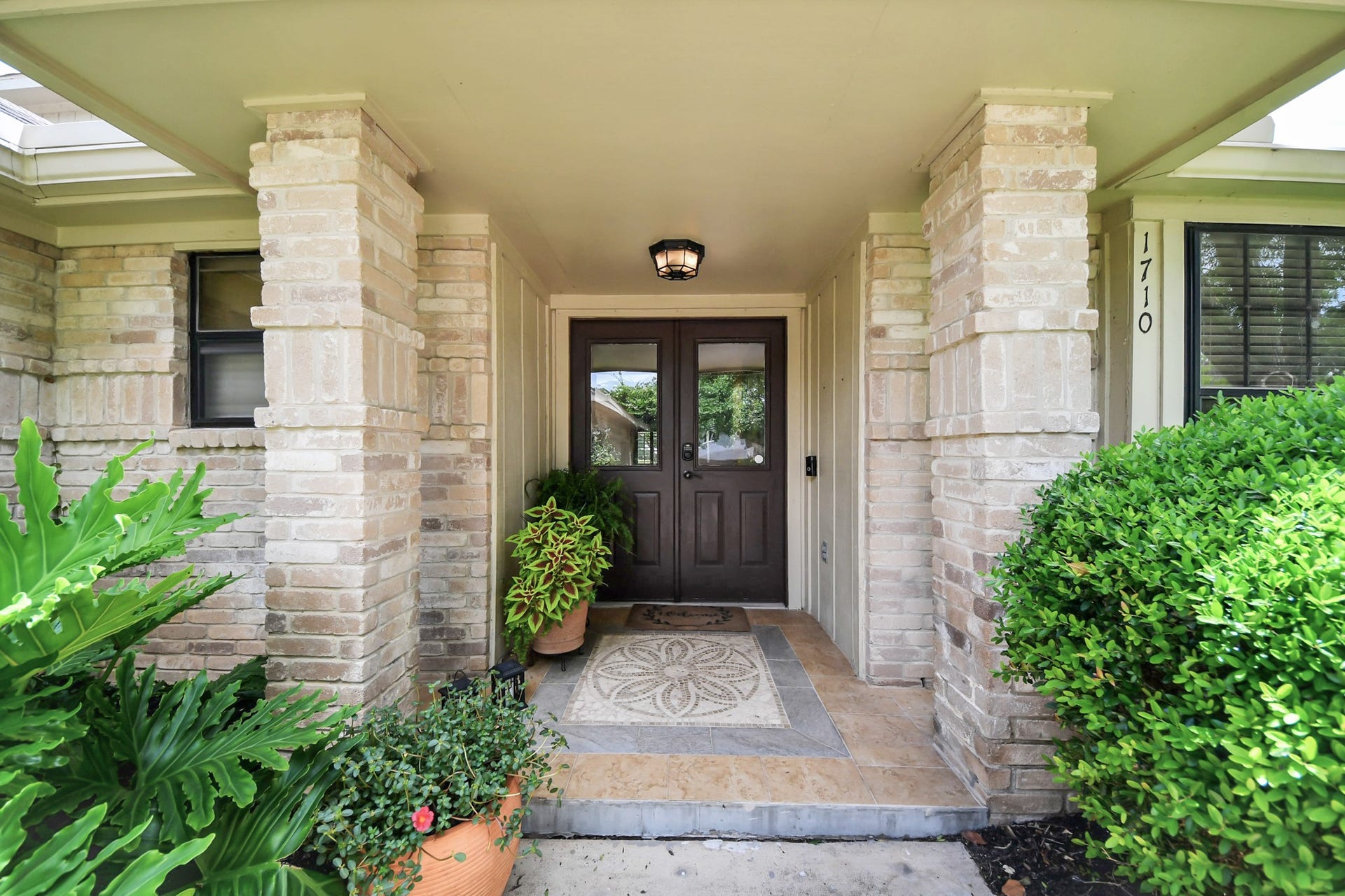 1710 Mayweather Lane, Richmond, TX 77406 A sheltered front porch and double-door entry create a welcoming arrival.