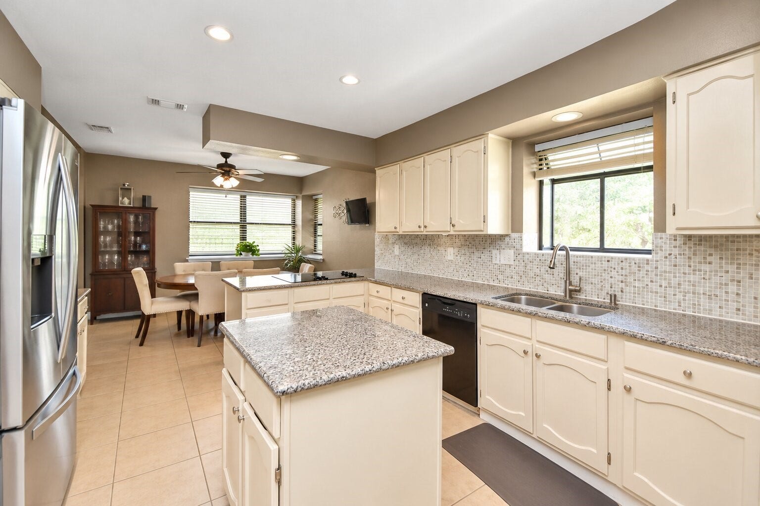 1710 Mayweather Lane, Richmond, TX 77406 A center island, generous workspace, and adjacent breakfast area support both casual meals and entertaining.