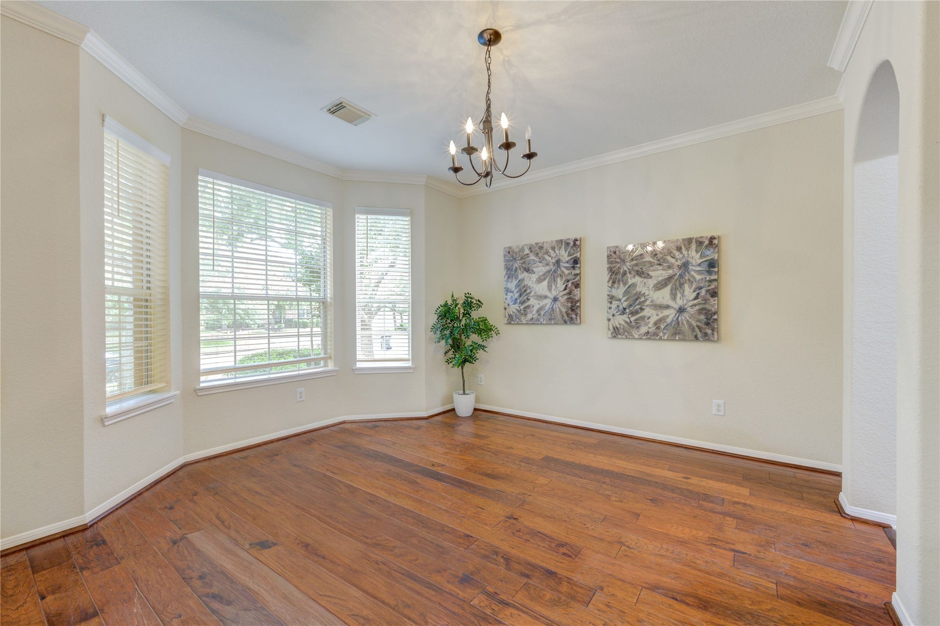 7811 Ravens Point Drive, Richmond, TX 77406 Elegant formal dining room crown molding and oversized windows perfect for hosting gatherings.