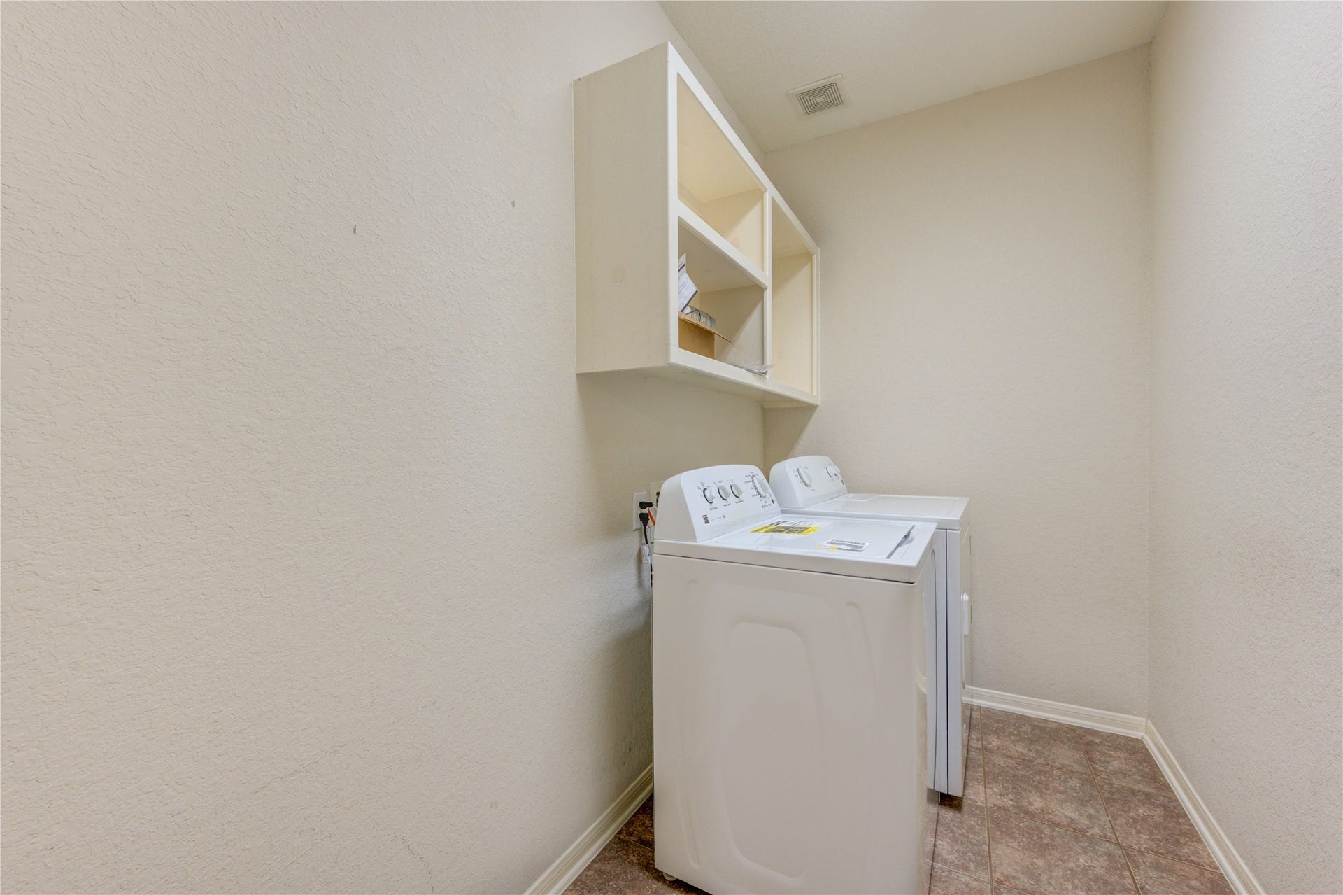 7811 Ravens Point Drive, Richmond, TX 77406 Utility room with built-in shelving and extra storage to keep everyday tasks organized and convenient.