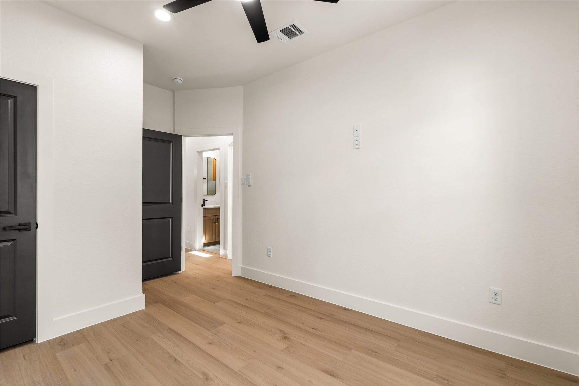 5321 Rue Street, Houston, TX 77033 Spacious room perspective effortless traffic flow, rich wood-look flooring, and seamless access to full guest bath.