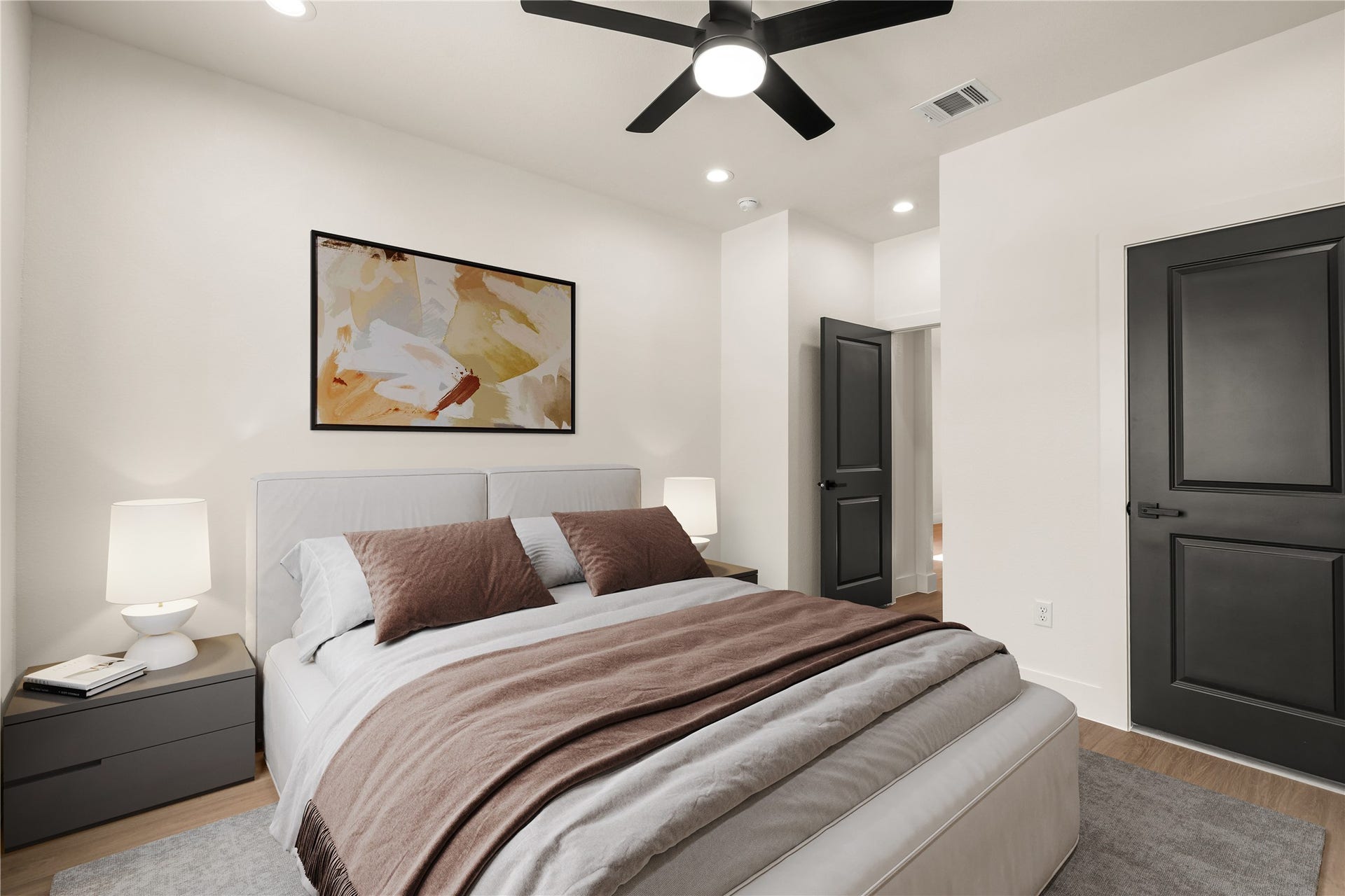 5321 Rue Street, Houston, TX 77033 Primary bedroom with room for a king, matte black doors, and a ceiling fan overhead. Virtually staged.