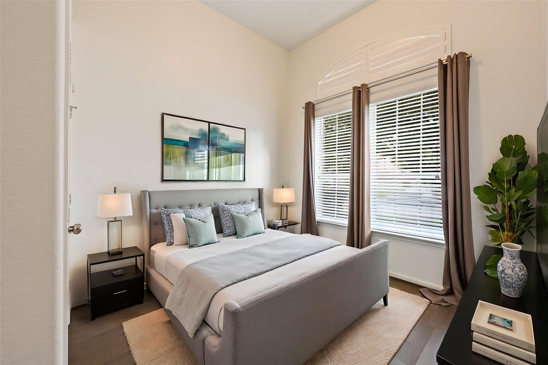 Secondary first-floor bedroom with large windows and natural light.